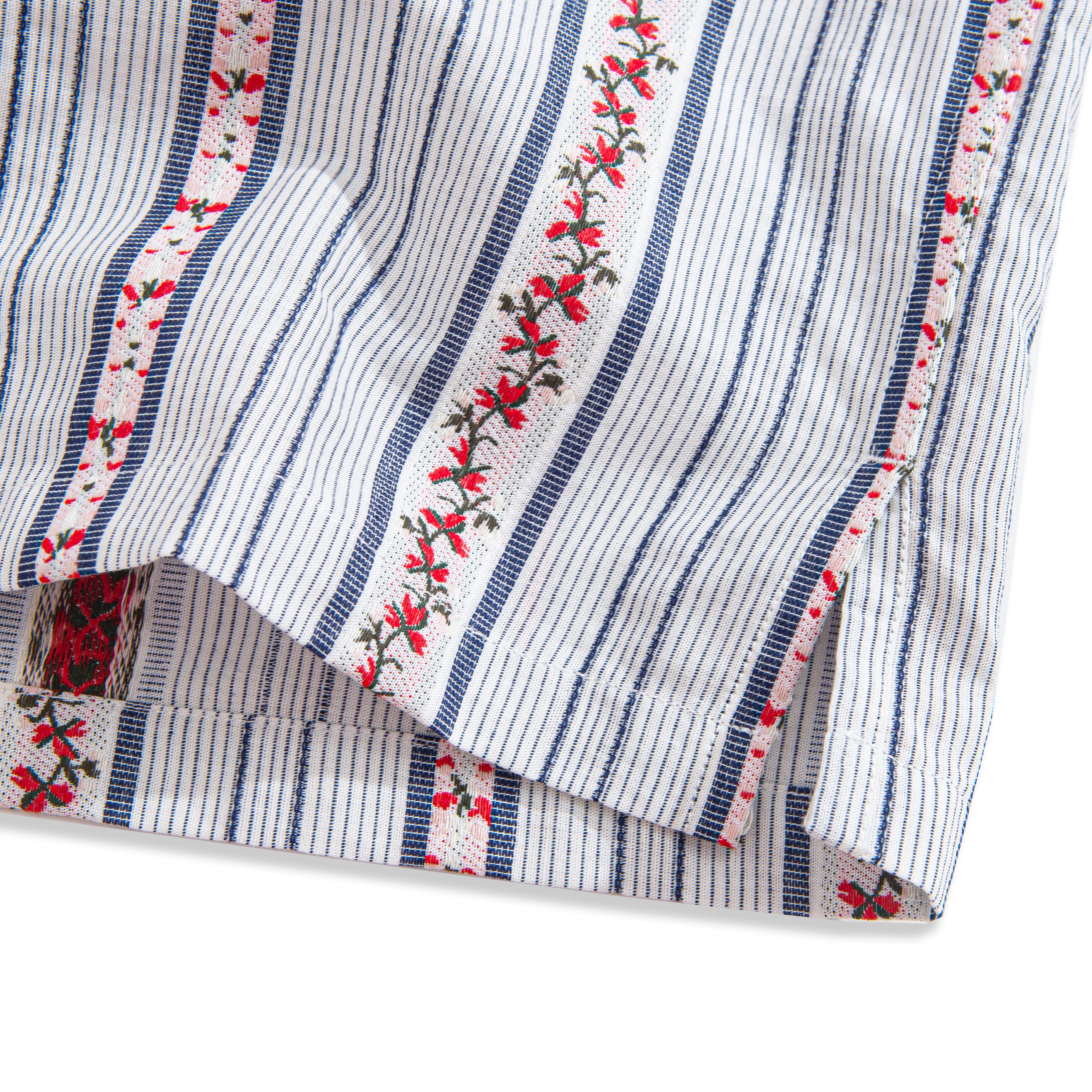 Back detail of striped shirt with box pleat and natural coconut buttons