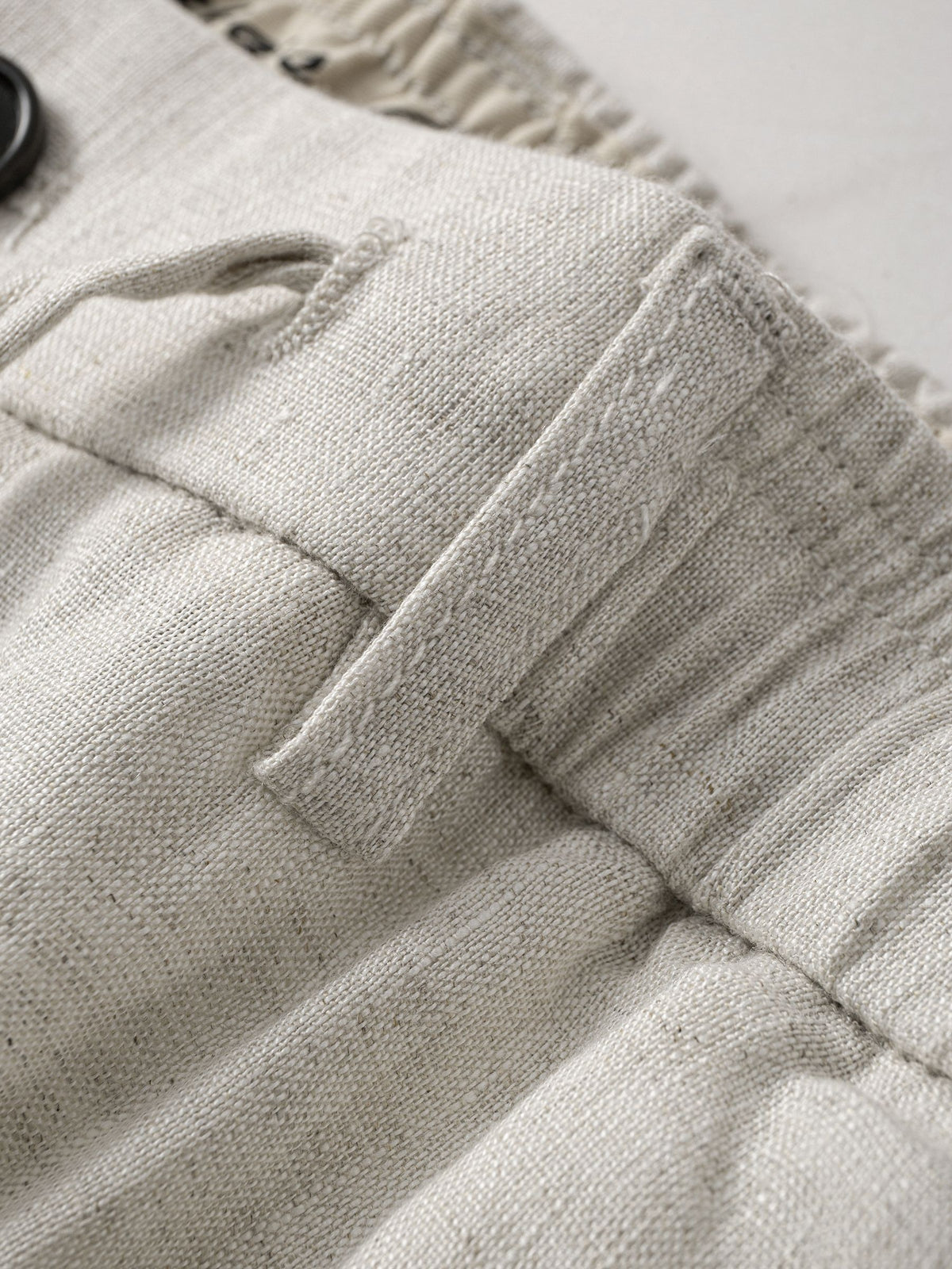 Belt loop detail on OROMEN Crosshatch Weave Relaxed Trousers