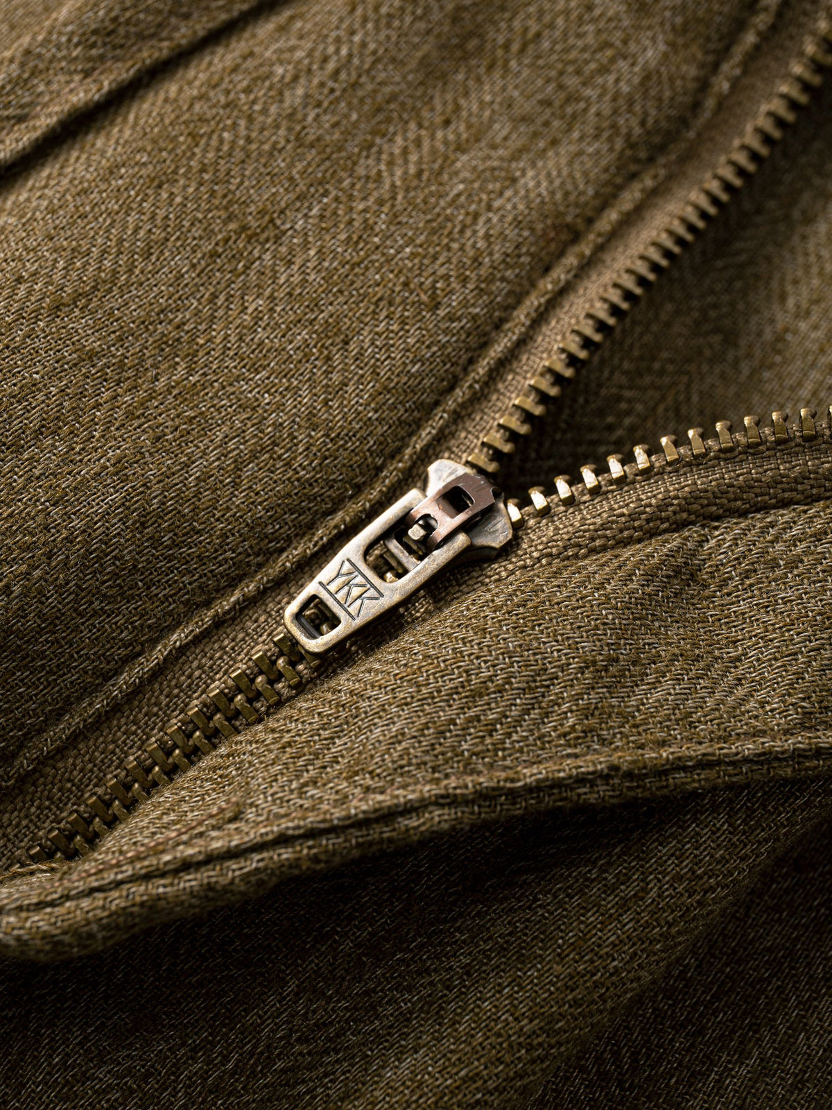 Button fly and zipper closure detail of OROMEN Herringbone Weave Linen Trousers