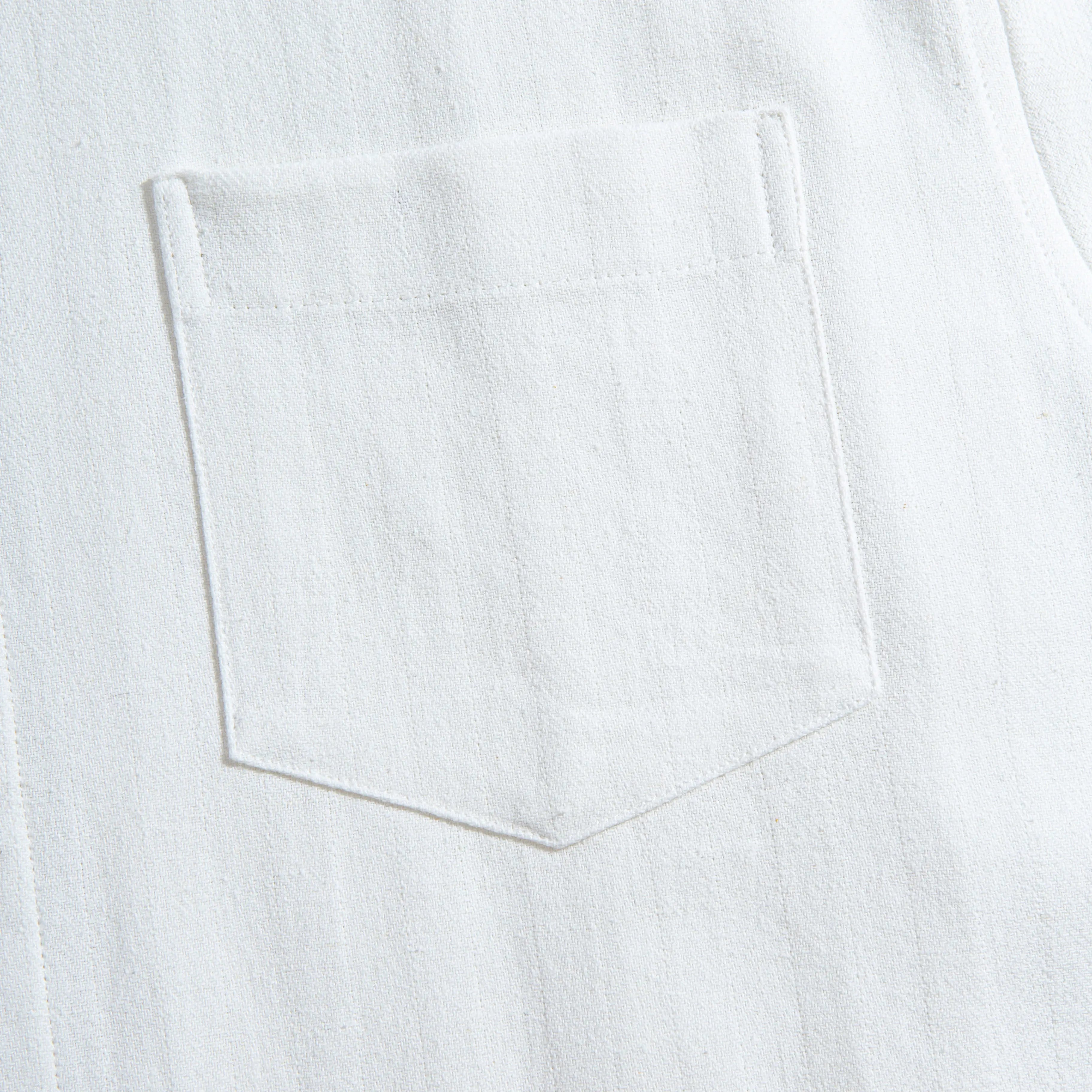 Chest pocket detail of OROMEN Embossed Striped Shirt – white Tencel™ linen with tonal embossed stripe texture