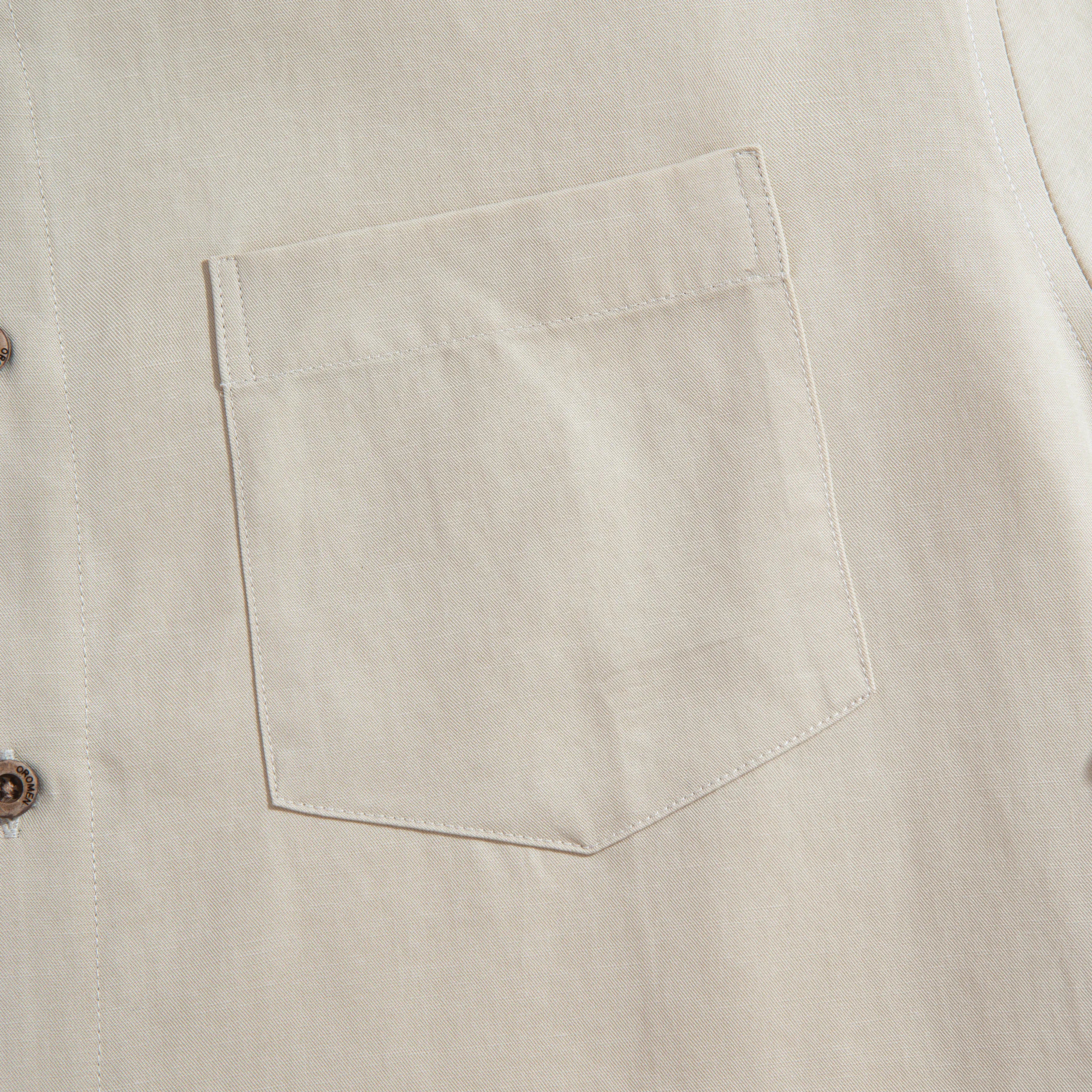Chest pocket detail of OROMEN Versatile Shirt – beige Tencel™ linen with clean patch pocket and coconut button
