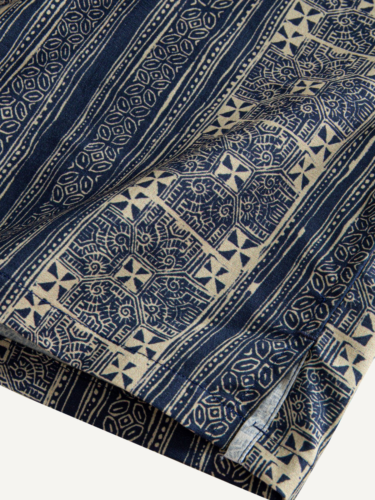 Clean hemline and side vent detail of OROMEN Indigo Batik Shirt