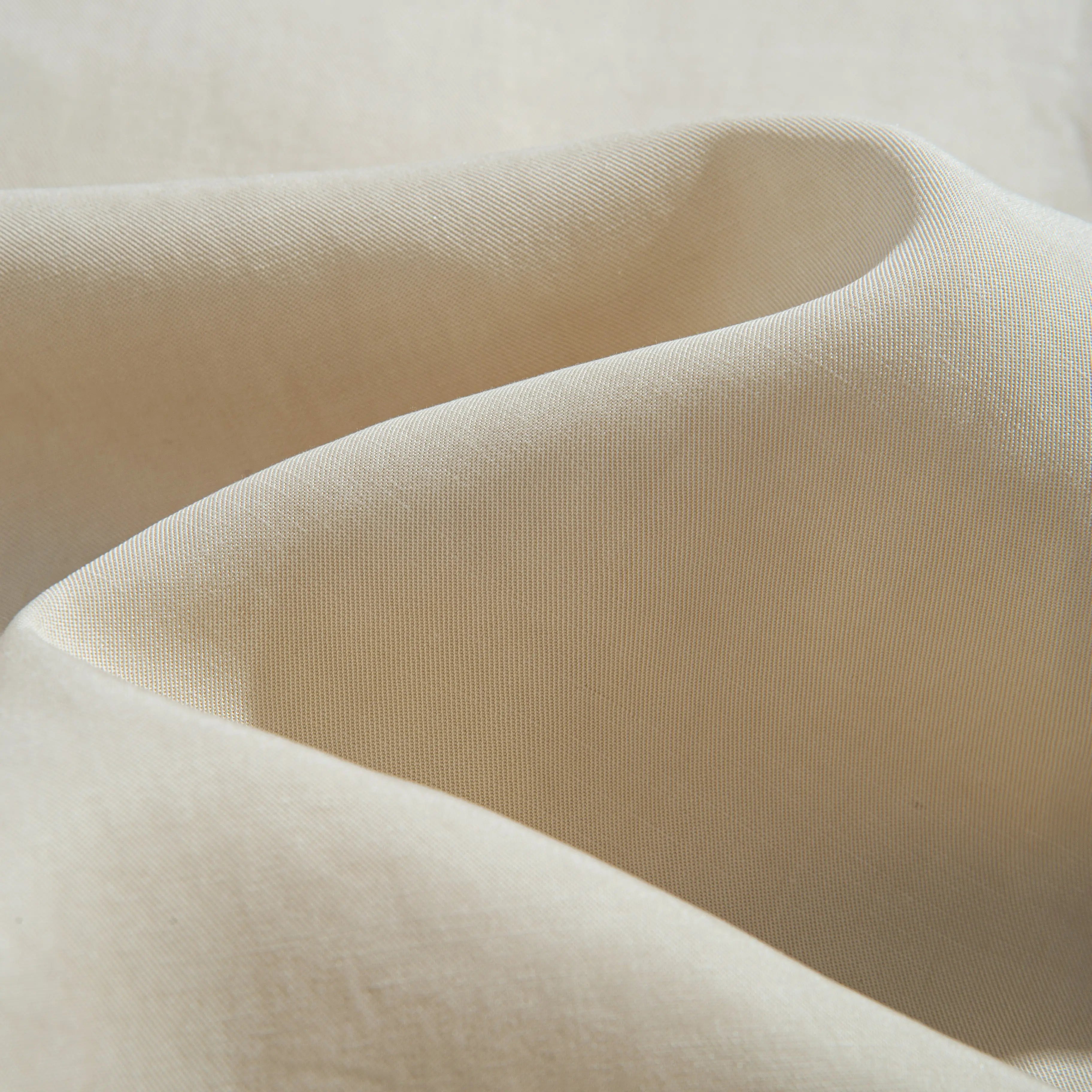 Close-up of OROMEN Versatile Shirt fabric – beige Tencel™ linen blend with silky smooth drape and natural sheen