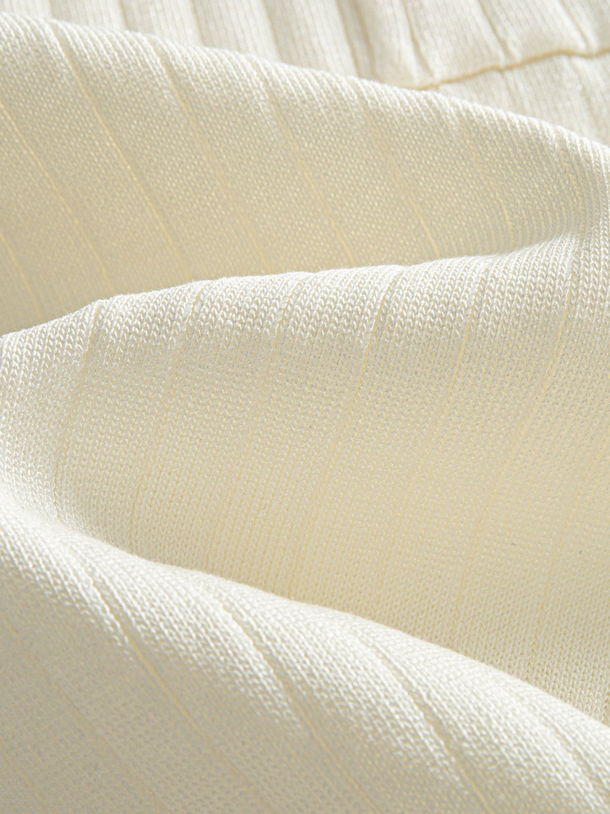 Close-up texture of ice silk fine rib knit fabric on OROMEN Cream Court Knit Polo