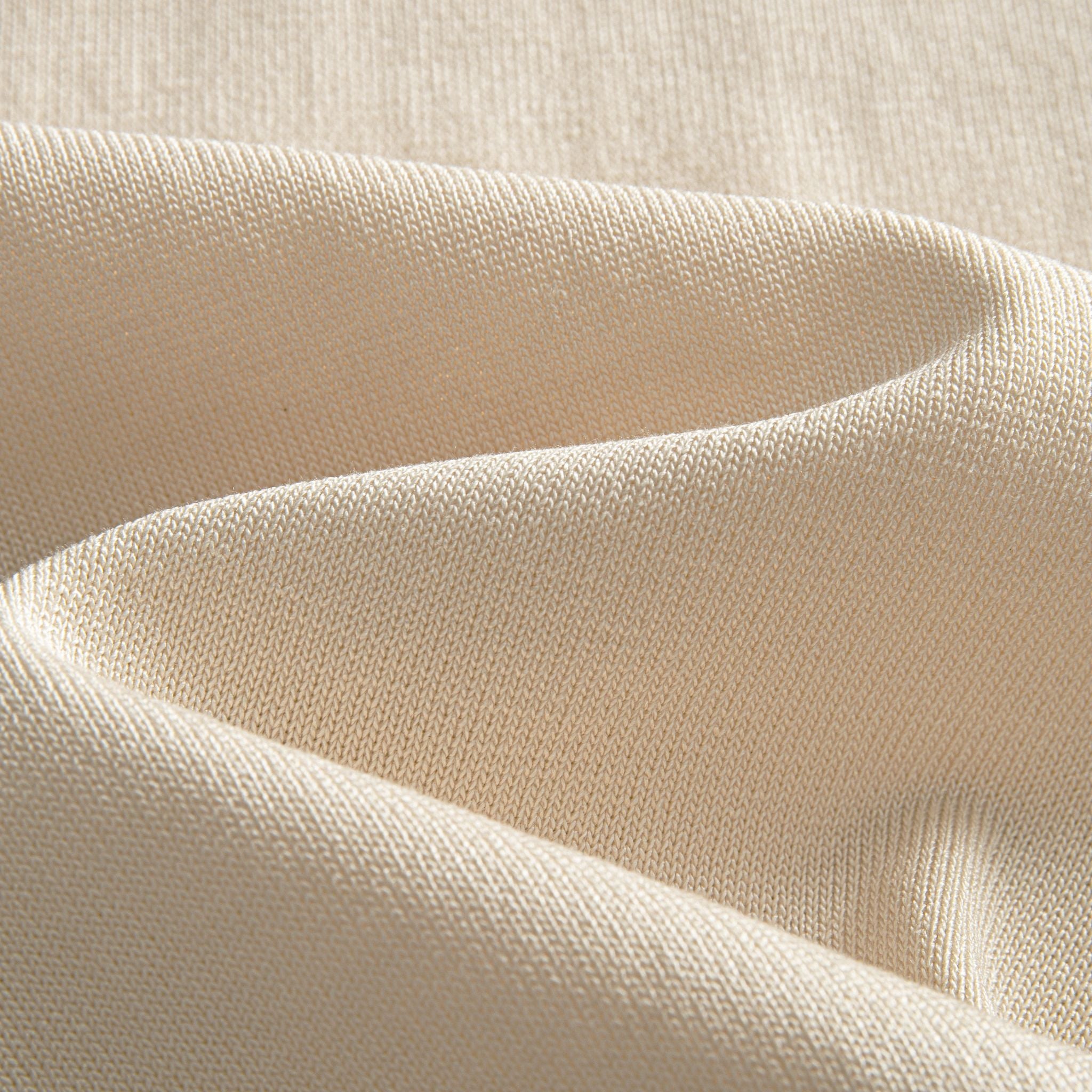 Close-up of cream 100% viscose knit fabric texture – OROMEN retro polo shirt