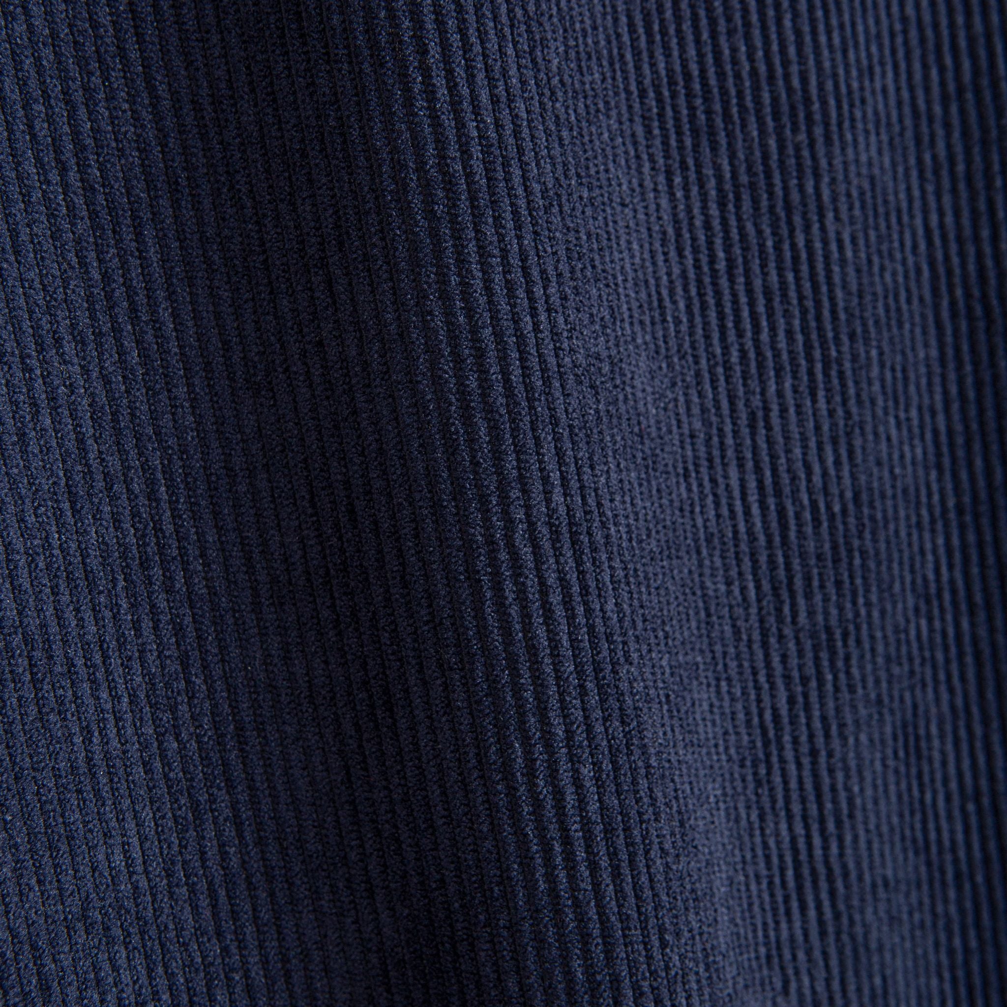 Close-up of navy blue 100% polyester corduroy ribbed texture on OROMEN colorblock hooded shirt