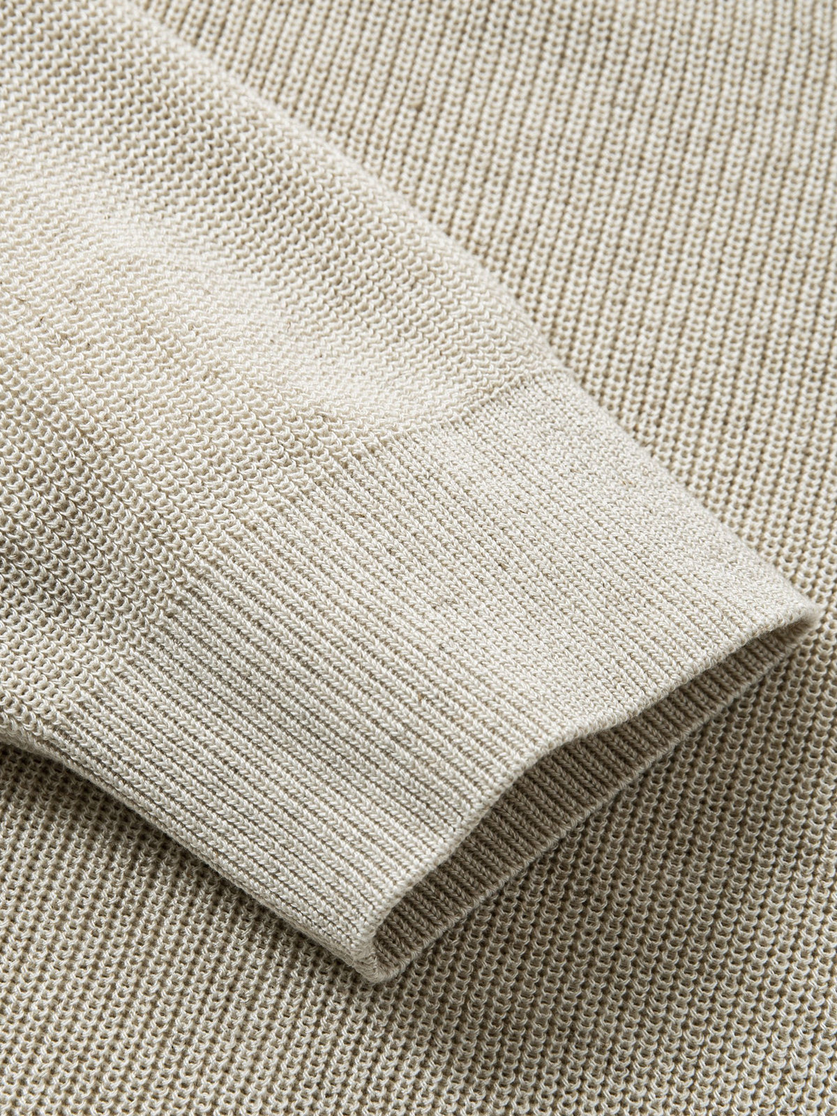 Detailed view of long sleeve ribbed cuffs on oatmeal sweater cardigan