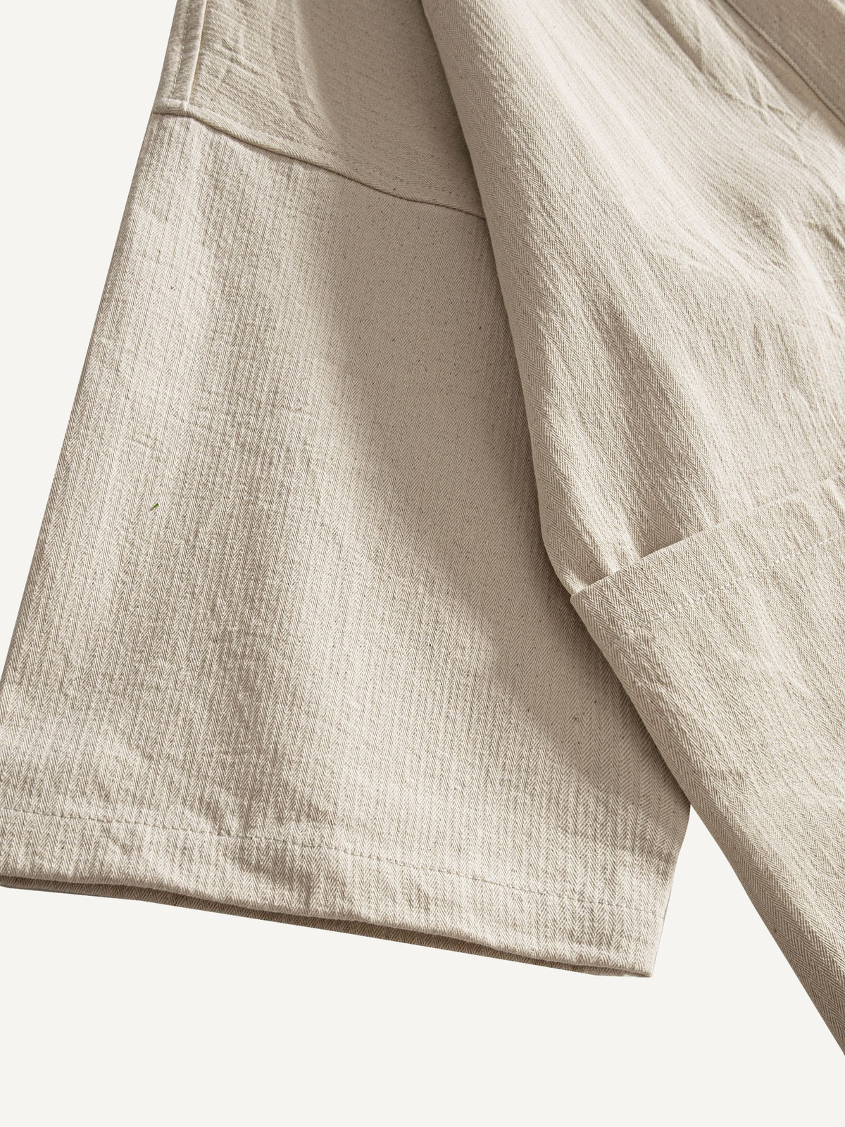 Detailed view of wide 3/4 length drop-shoulder sleeve cuff on beige kimono cardigan