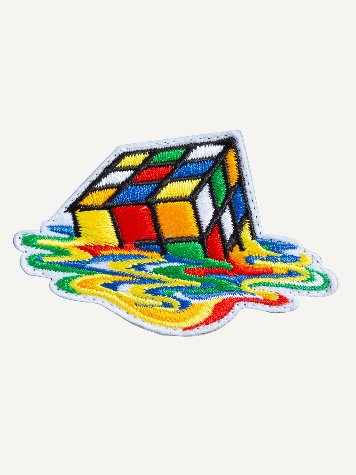 Embroidered melting Rubik's cube artwork detail on OROMEN T-shirt