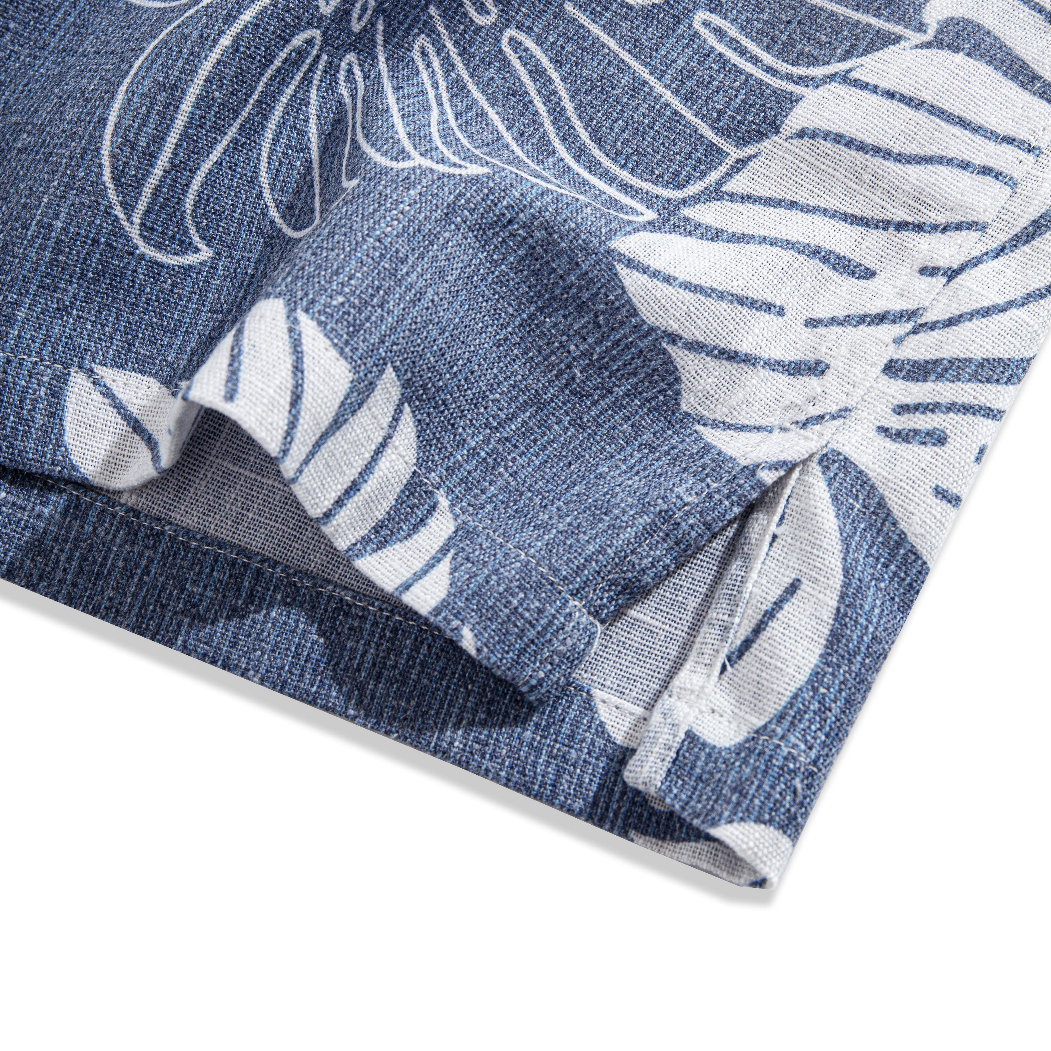 Hand-painted Monstera leaf pattern detail on navy linen shirt