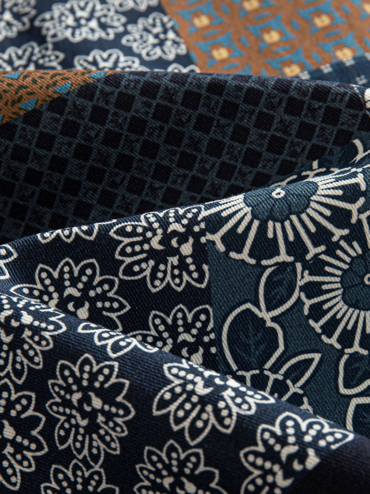 Macro texture close-up of 100% cotton twill fabric featuring Japanese Asanoha star and geometric patchwork print
