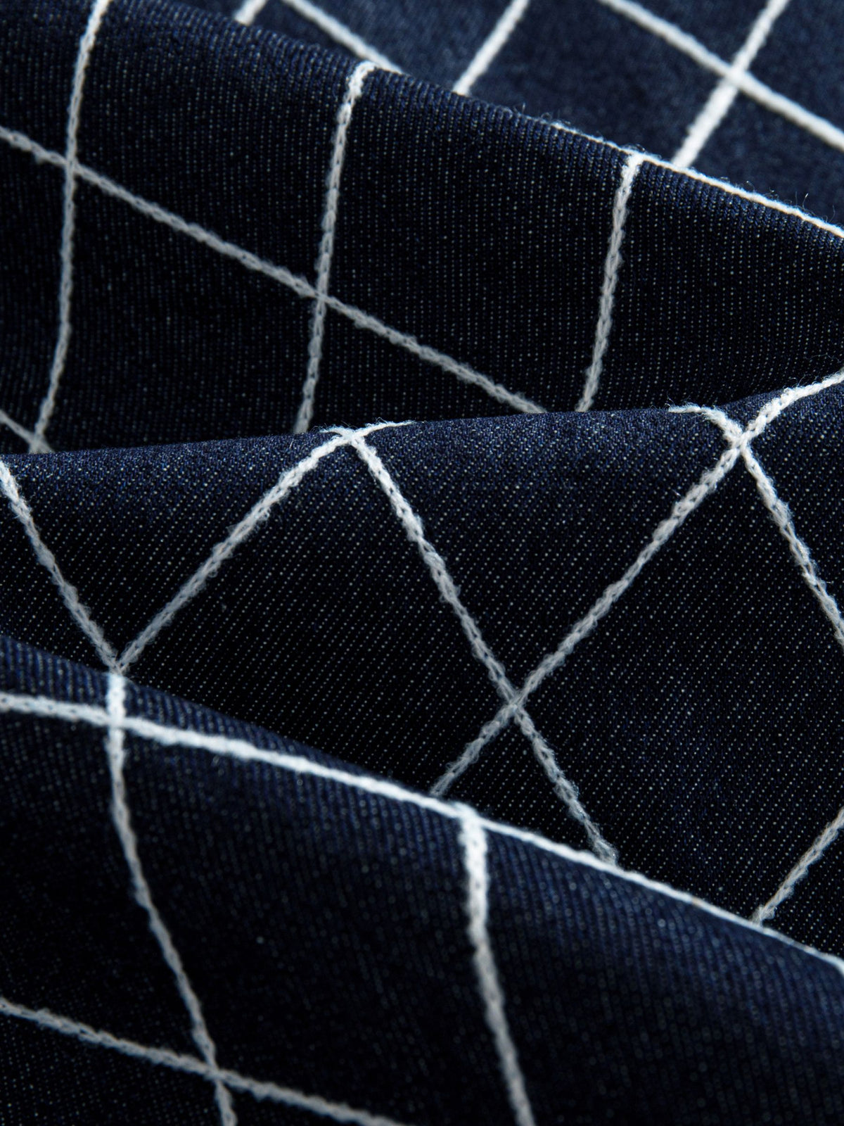 Macro texture close-up of 86% cotton blend fabric and white diamond lattice print