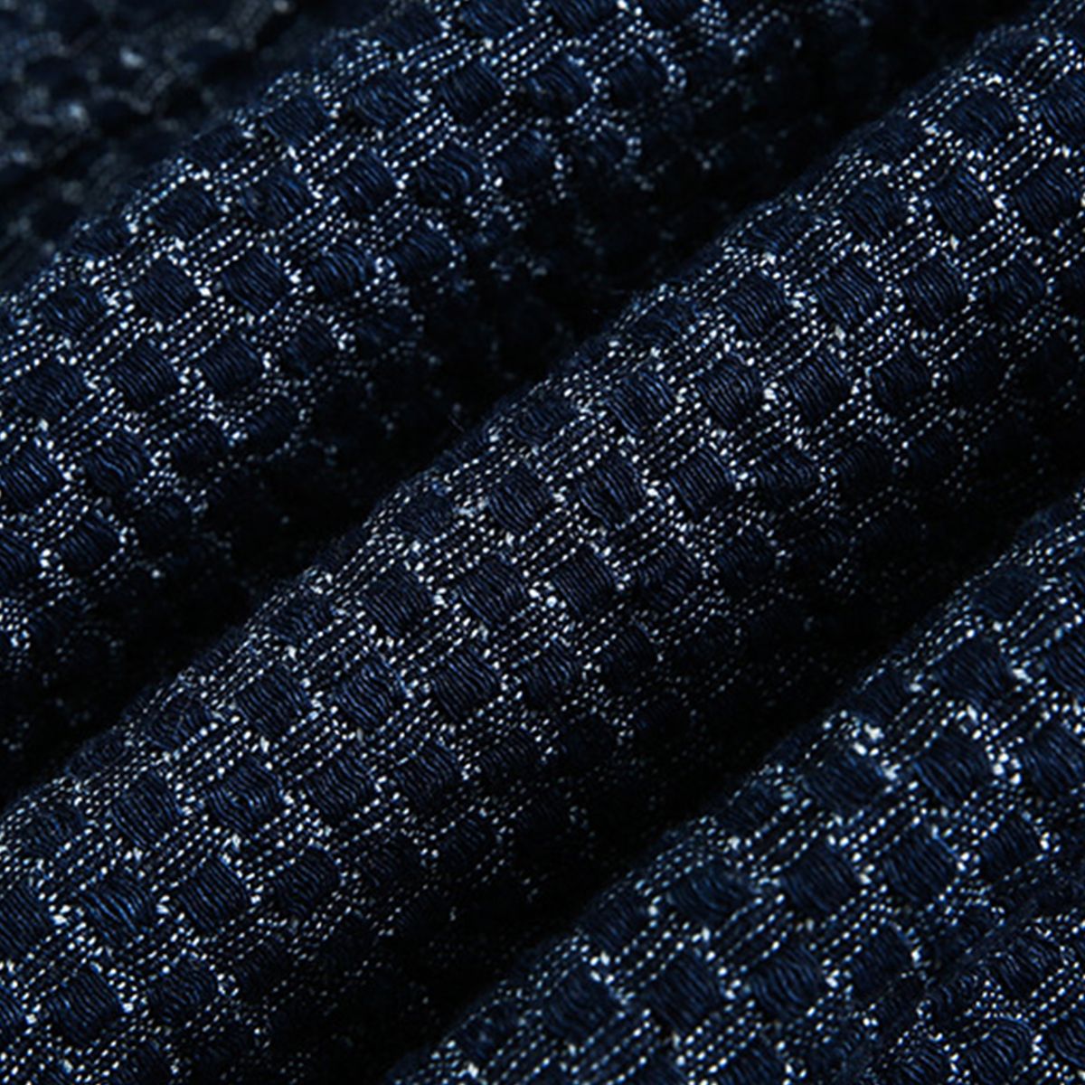 Macro detail of OROMEN OROAW042 jacquard fabric, navy blue checkered woven pattern, raised texture surface, 100% cotton craftsmanship