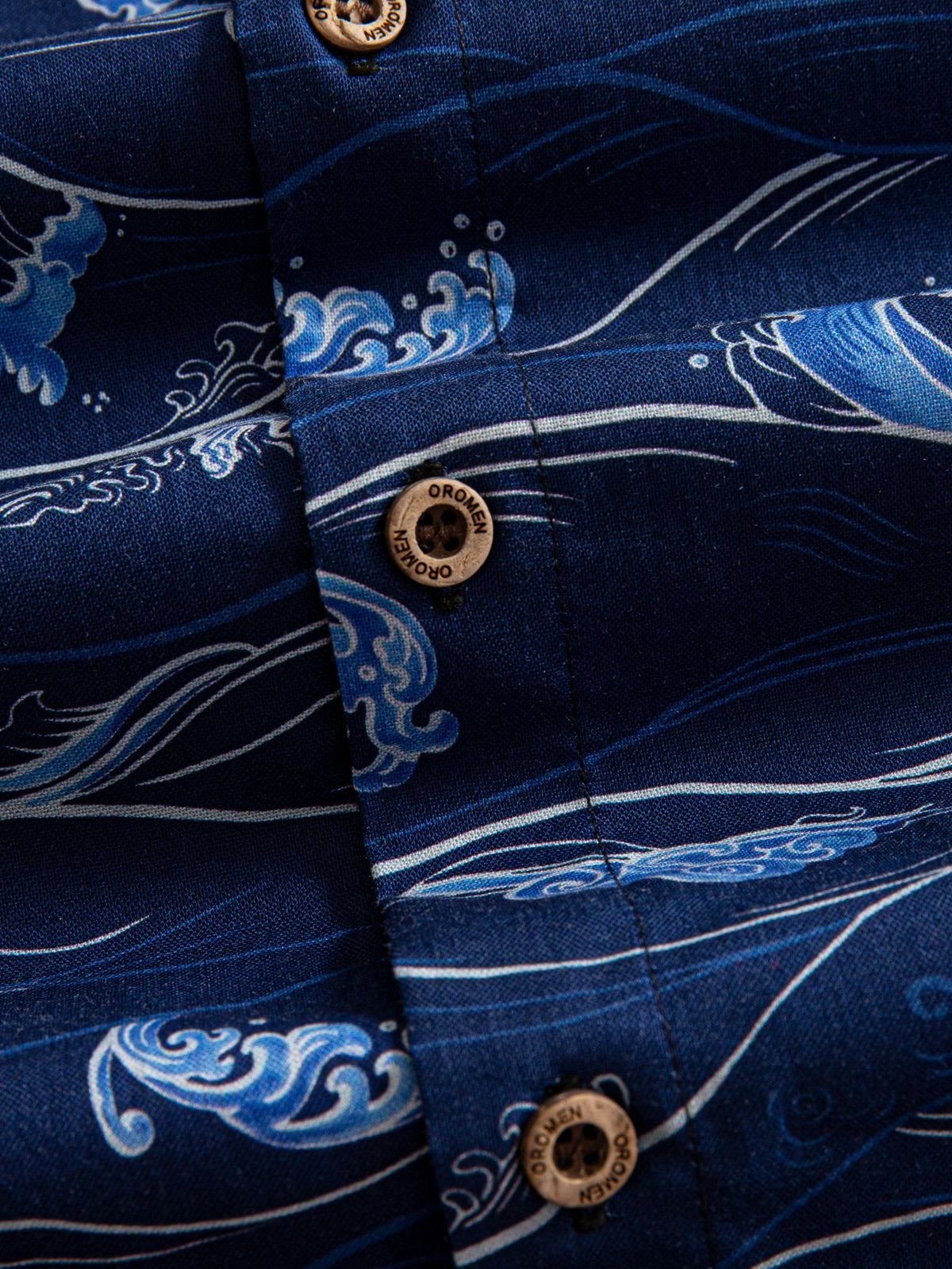 Natural coconut button closure and front placket detail of OROMEN Hokusai Kairin Shirt