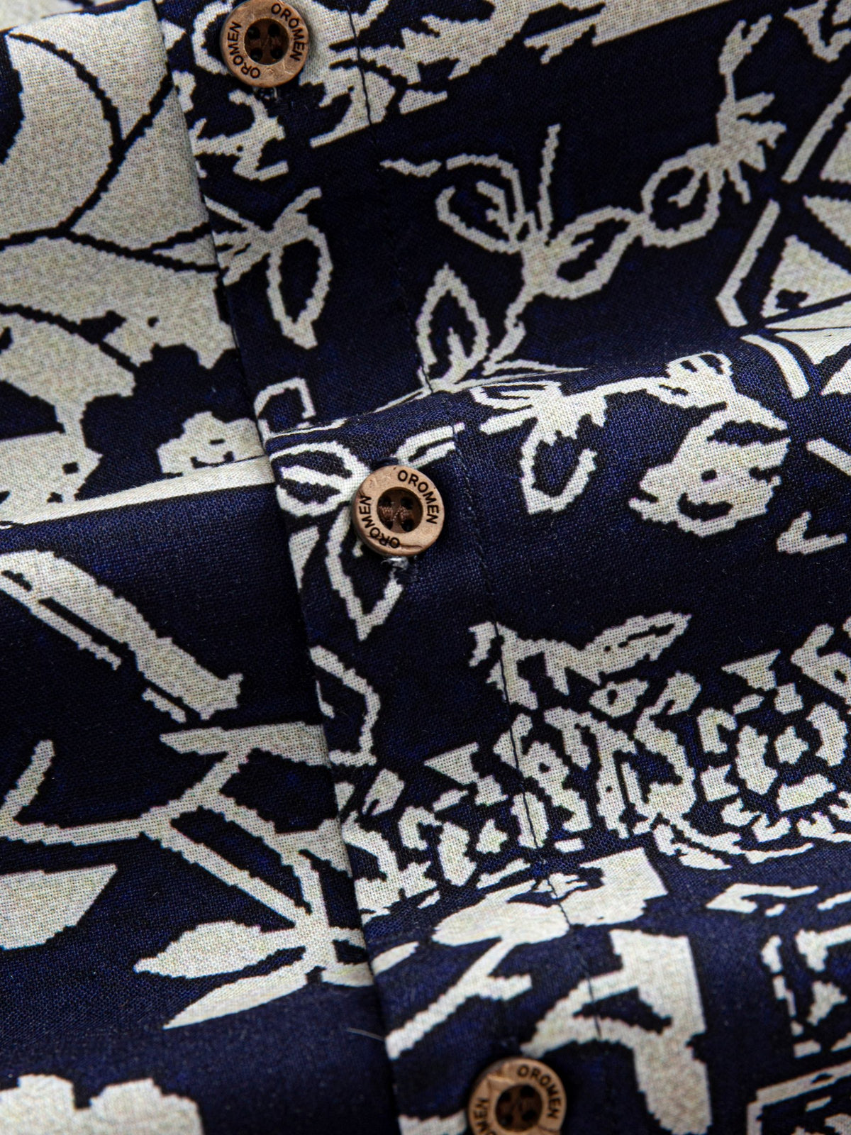 Natural coconut button closure and front placket detail of OROMEN Indigo Katazome Shirt