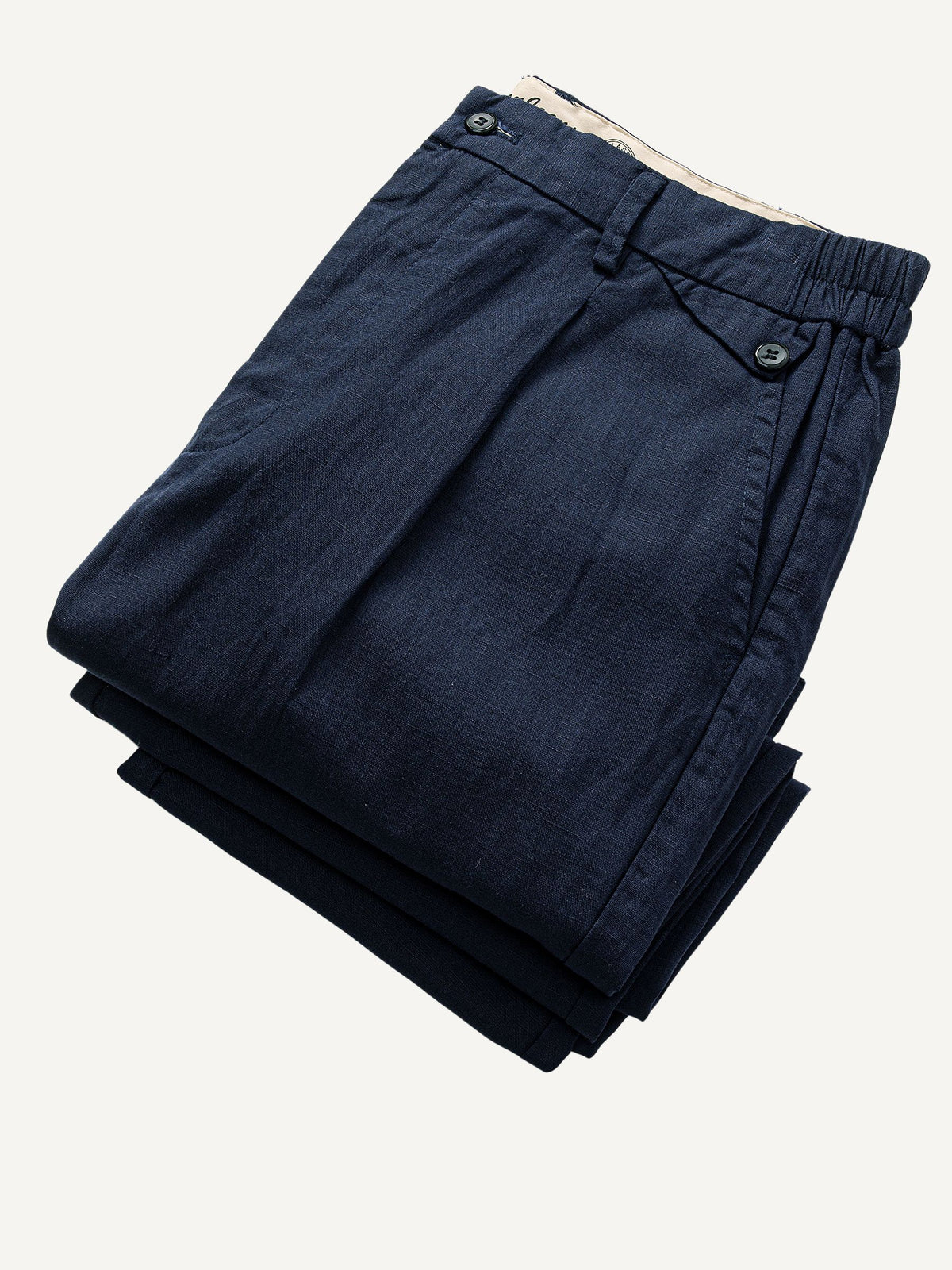 Neatly folded view of OROMEN Pleated Relaxed Fit Linen Trousers in Navy