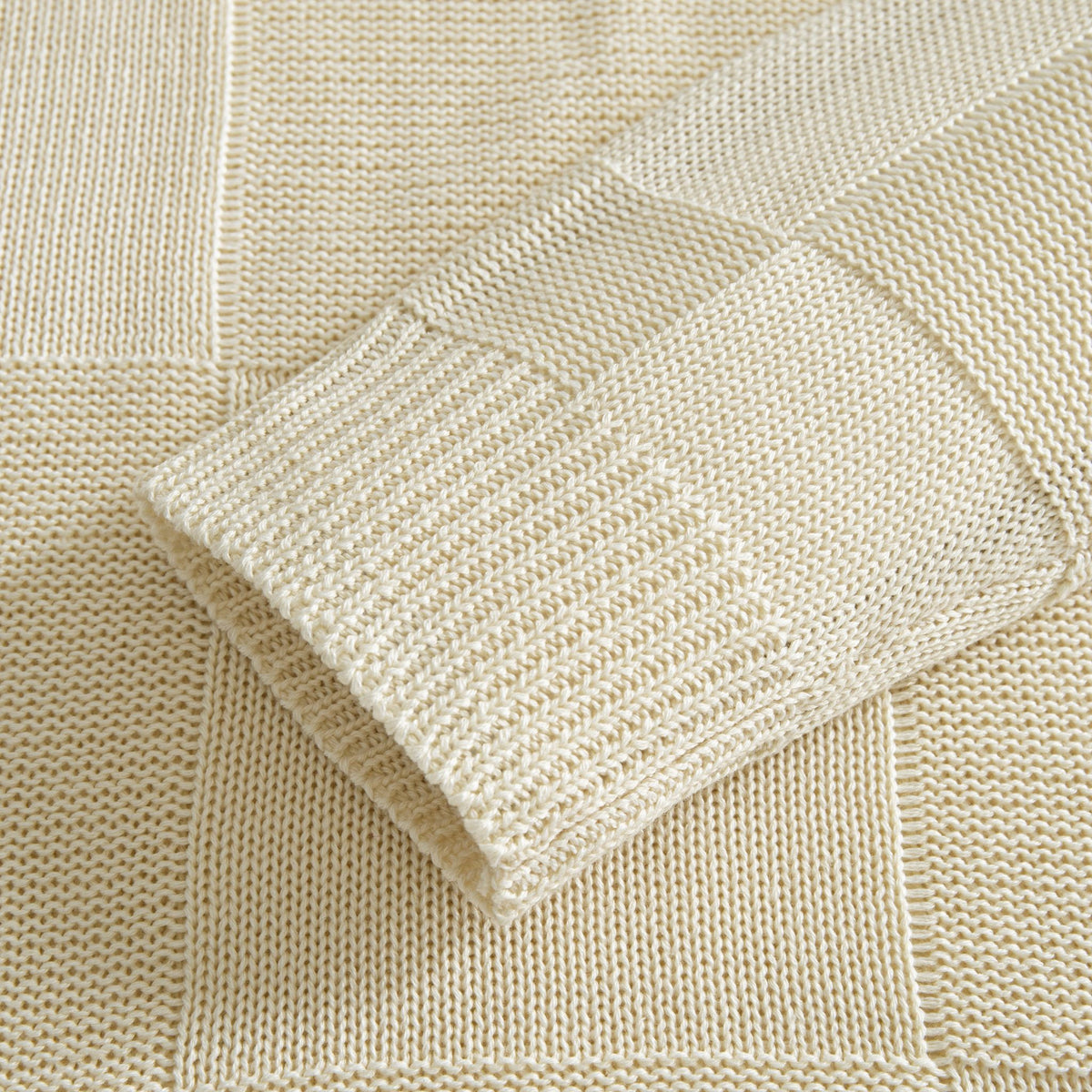 OROMEN Checkerboard Textured Sweater cream sleeve ribbed cuff detail close-up