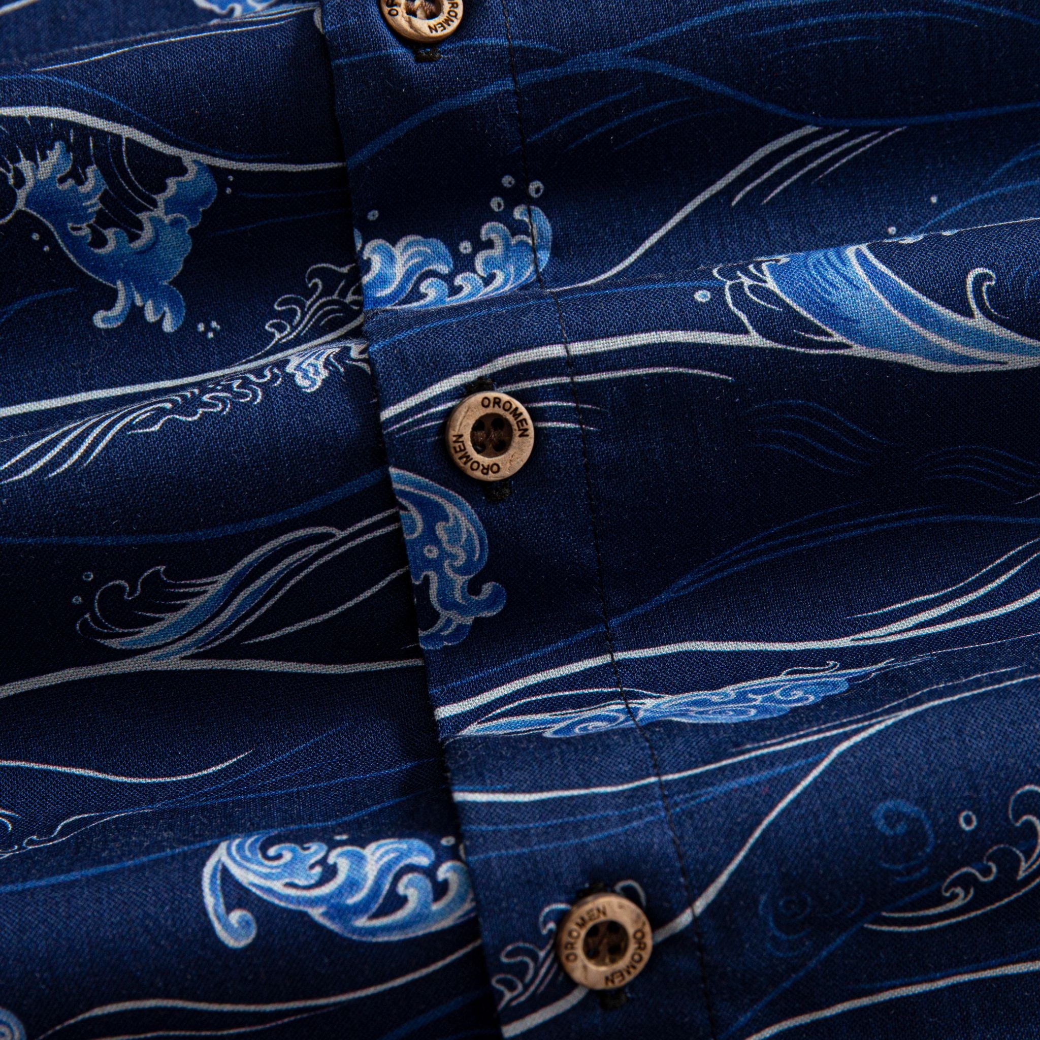 OROMEN Hokusai Kairin shirt branded coconut button close-up, Ukiyo-e wave print on deep navy