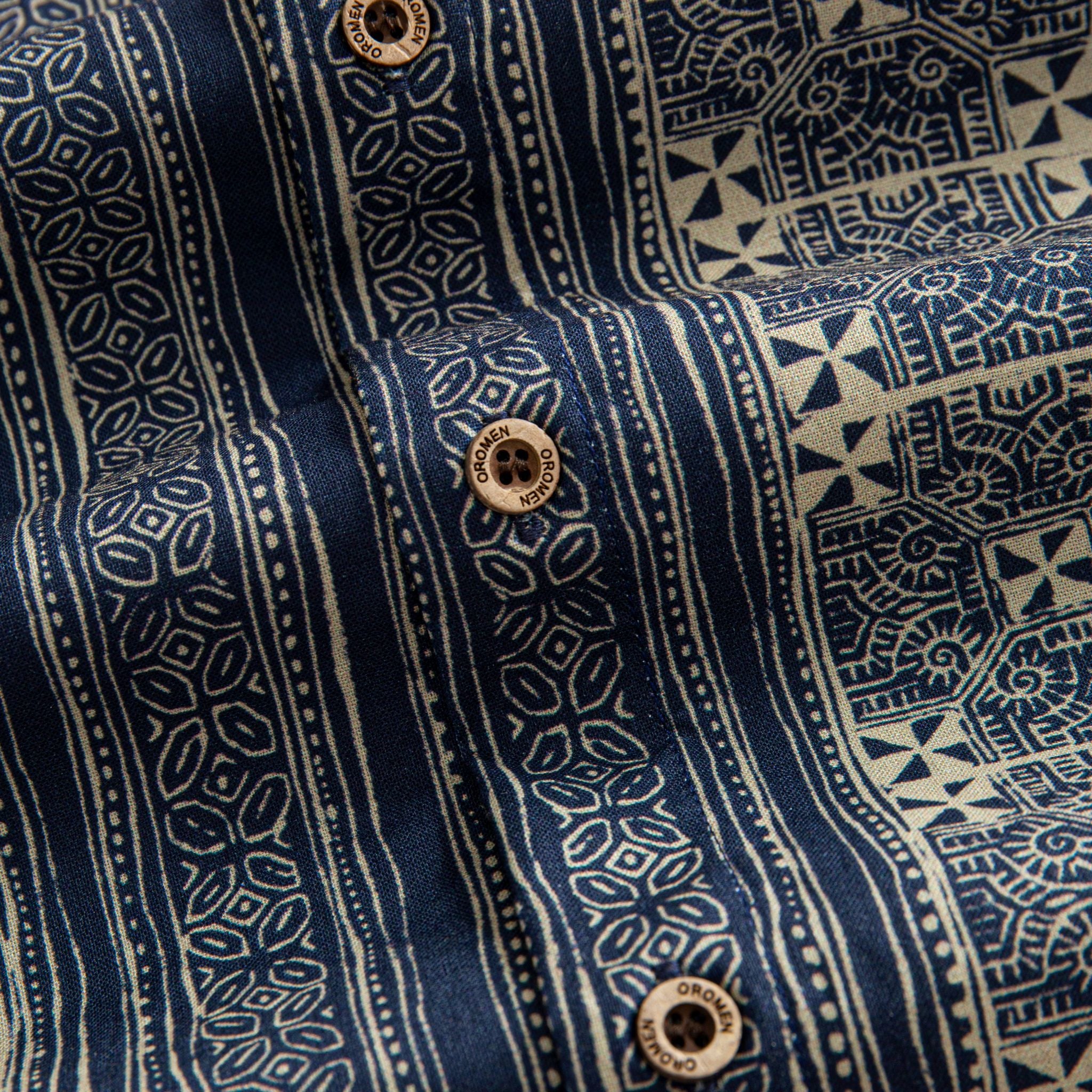 OROMEN Indigo Batik shirt branded coconut button close-up, navy and off-white geometric Batik print