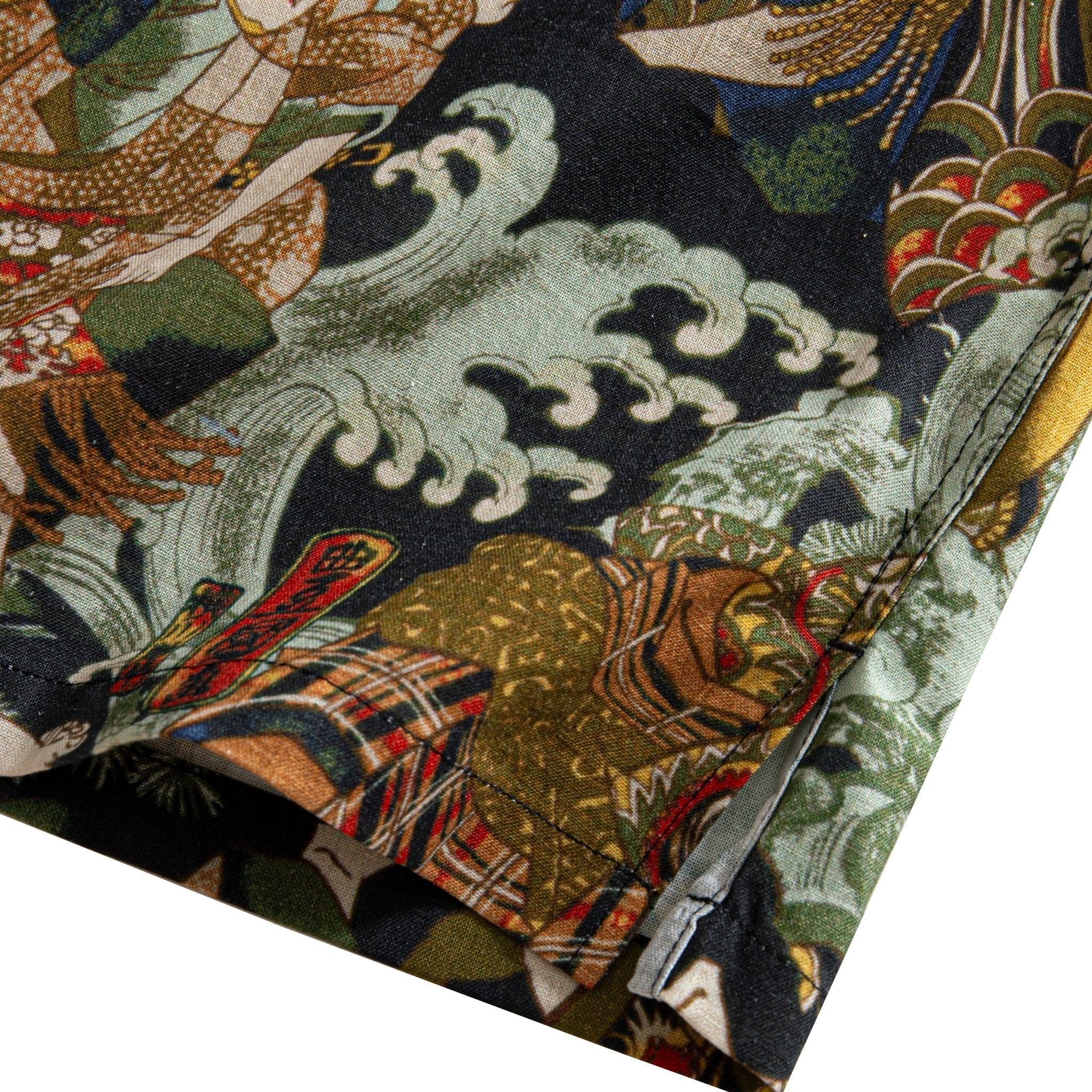 OROMEN Kabuki Warriors shirt side vent detail showing Kabuki warrior figures, wave motifs and double needle stitching on dark navy cotton