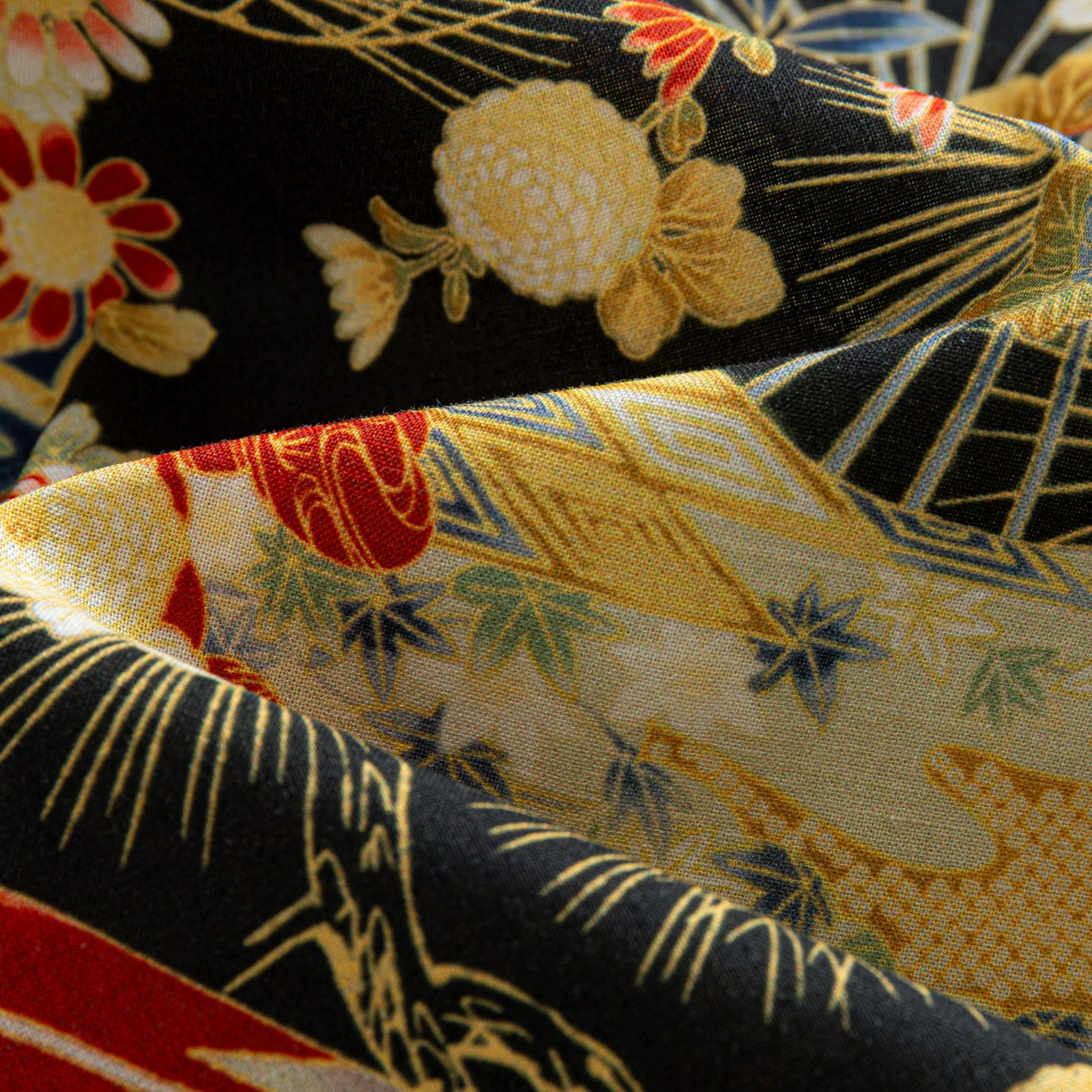 OROMEN Kiku & Fan shirt – draped fabric detail showing contrast between black ground and gold fan panels with kiku blooms red peonies and bamboo leaf motifs