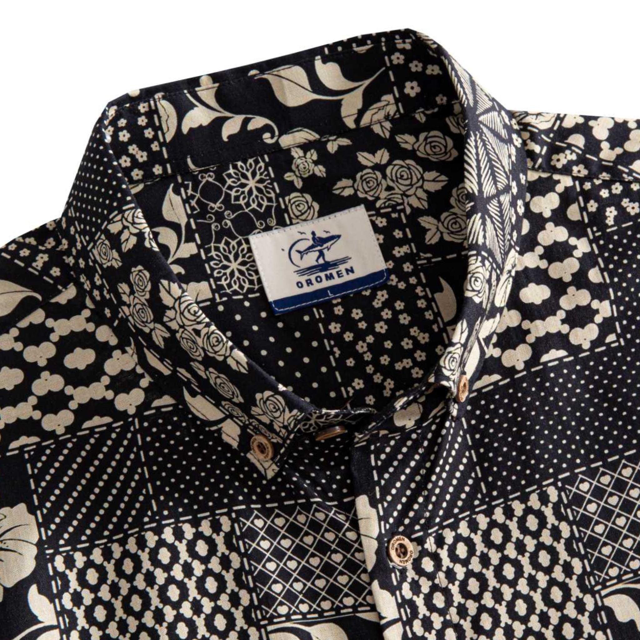 OROMEN Noir Patchwork shirt button-down collar detail showing OROMEN branded label and multi-motif monochrome patchwork panels in black and off-white