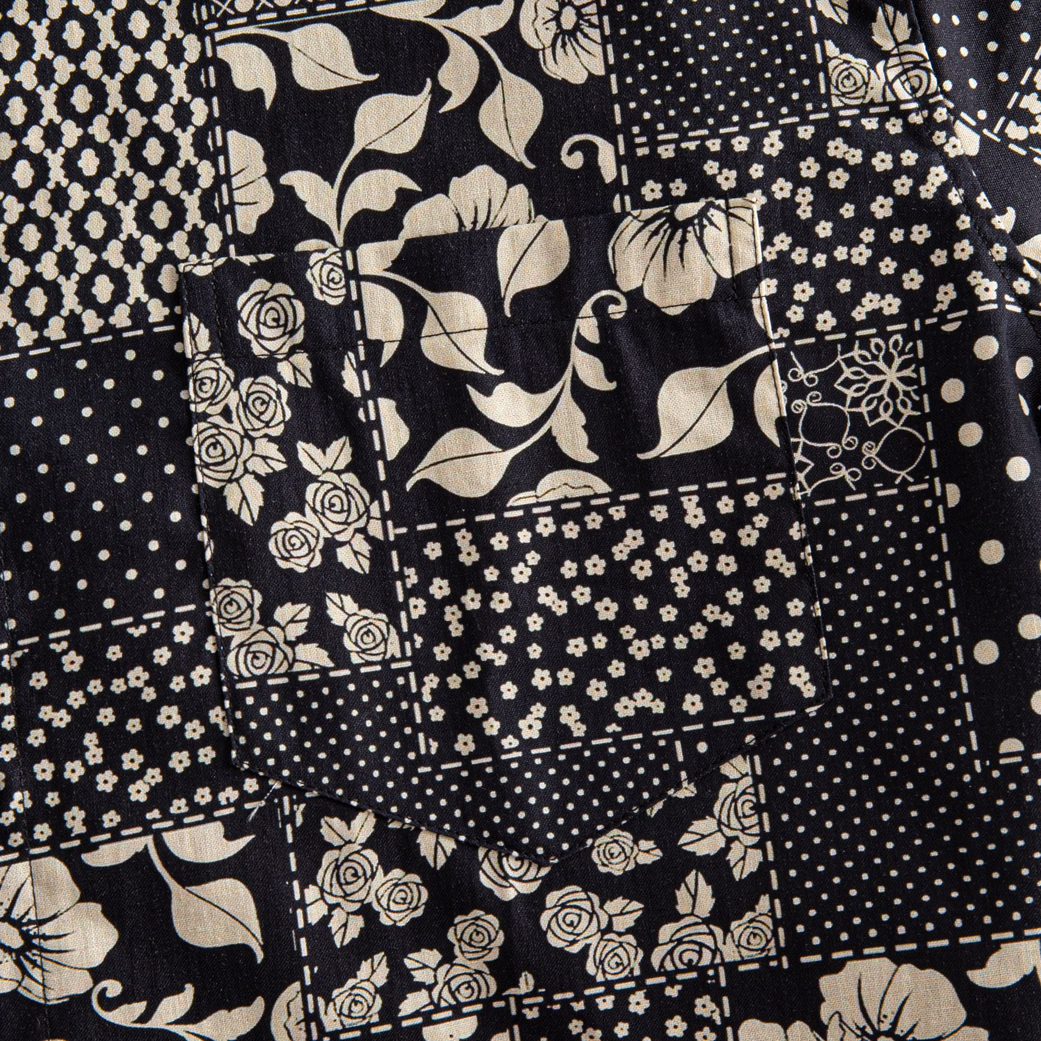 OROMEN Noir Patchwork shirt chest pocket close-up showing large floral, rose, daisy and polka dot patchwork print continuing across pocket seam in black and off-white