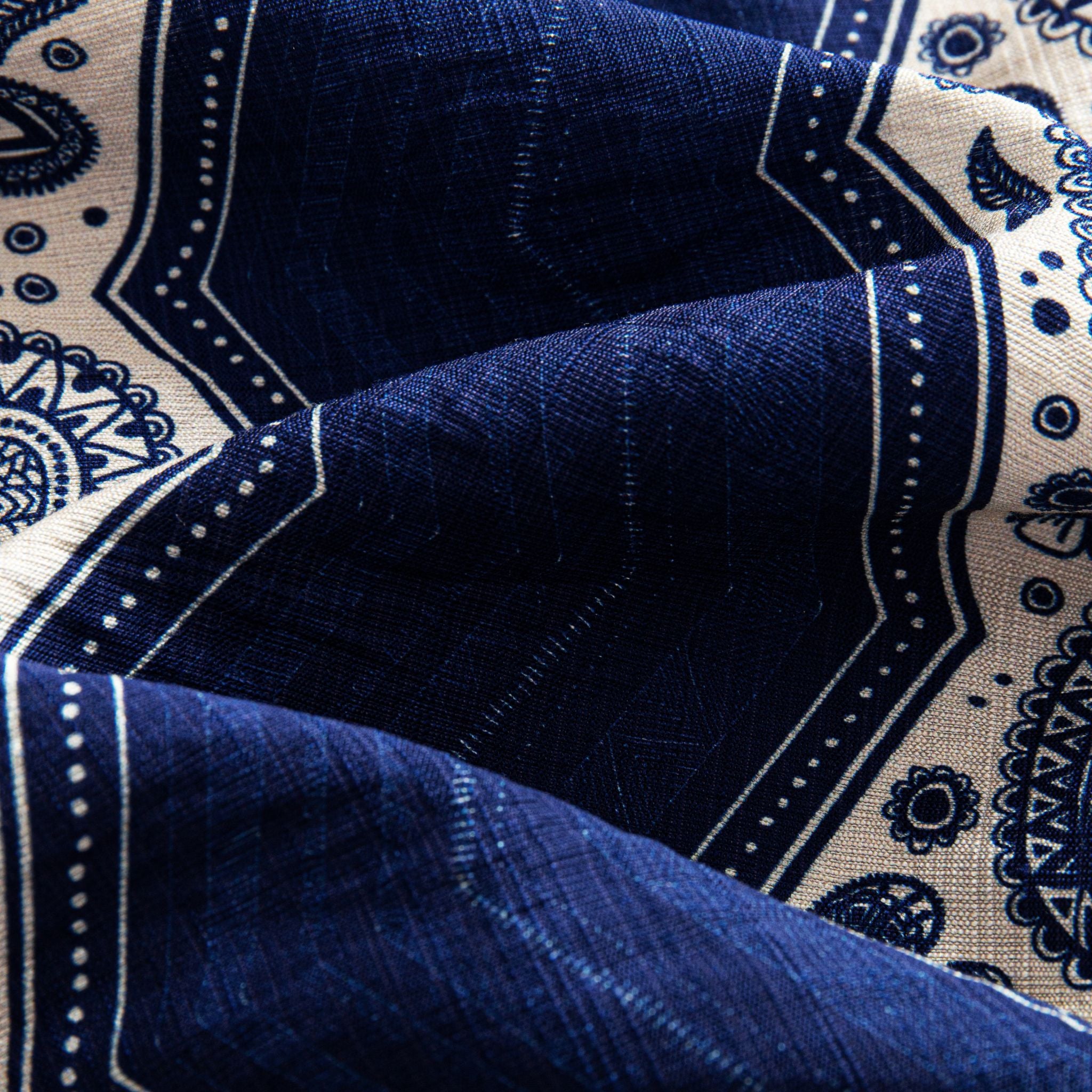 OROMEN Paisley Bandana shirt fabric close-up showing intricate navy blue paisley teardrop motifs and geometric frames on off-white rayon blend