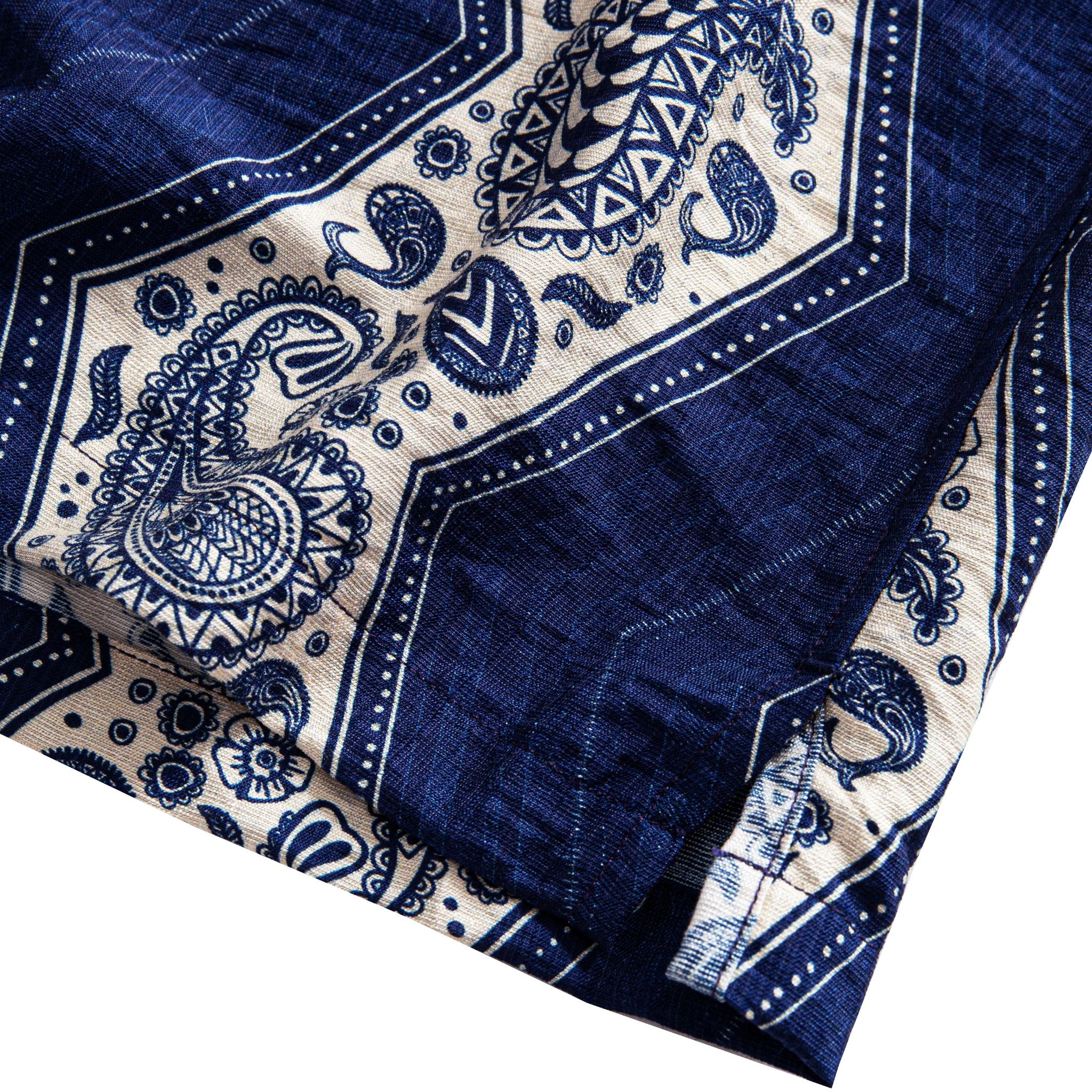 OROMEN Paisley Bandana shirt side vent detail showing hem opening with navy blue and off-white paisley print and geometric border