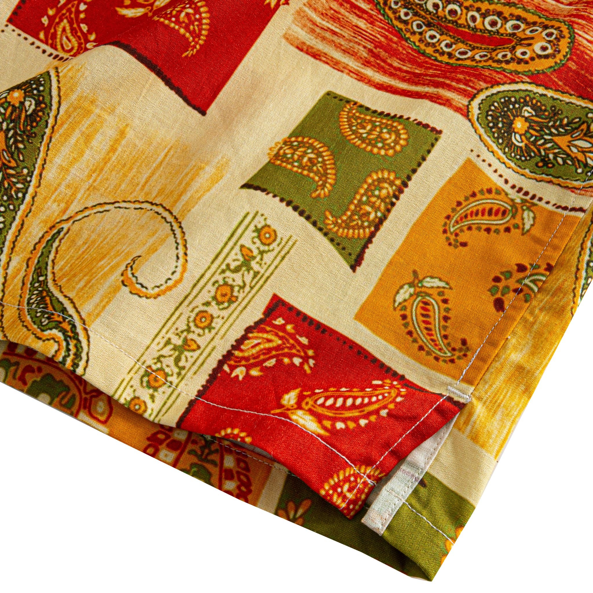 OROMEN Rajasthan Paisley shirt side vent detail showing multi-color paisley patchwork blocks in crimson, amber, olive and cream with double needle stitching