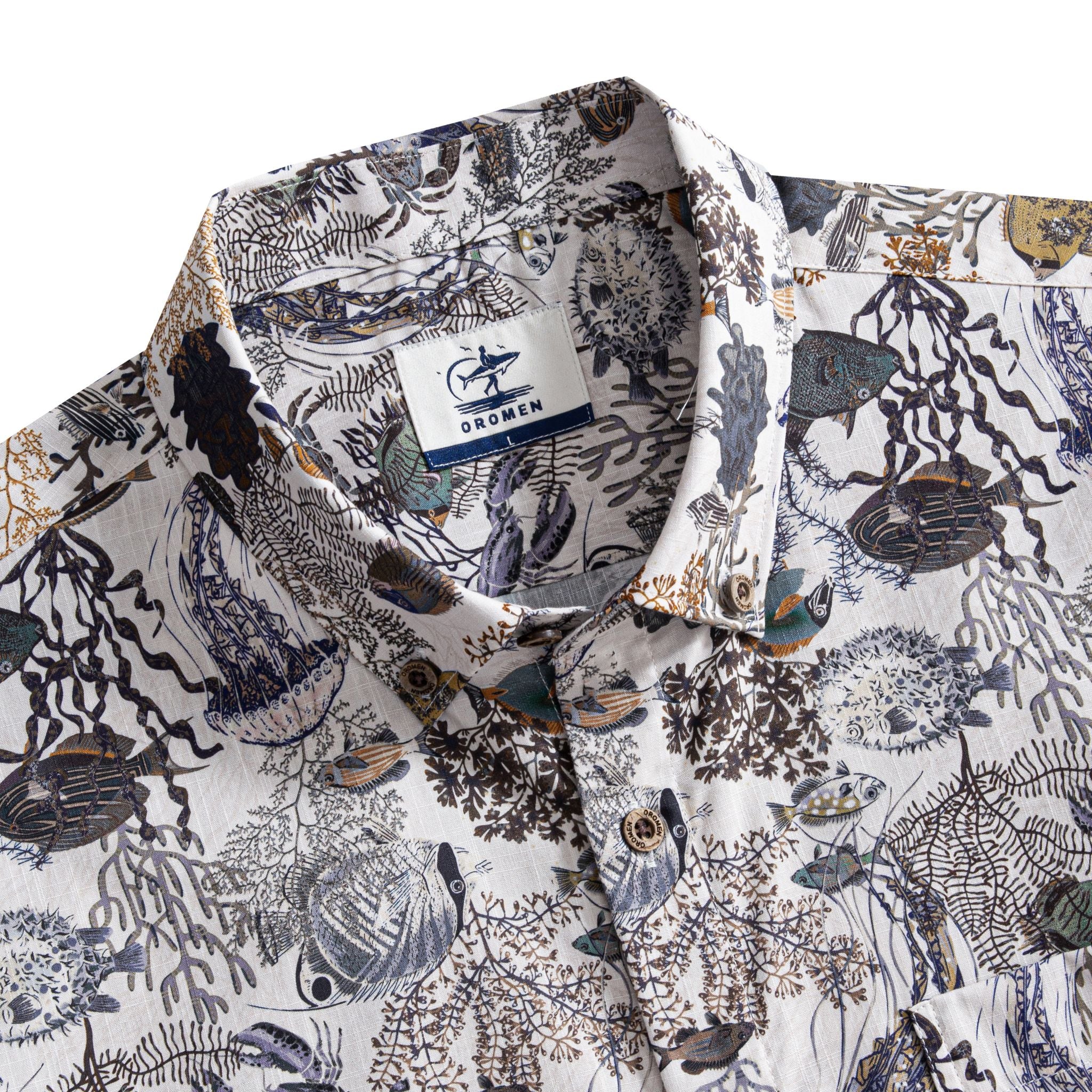 OROMEN Reef Atlas Hawaiian shirt – brand label and engraved coconut buttons detail on marine naturalist print collar