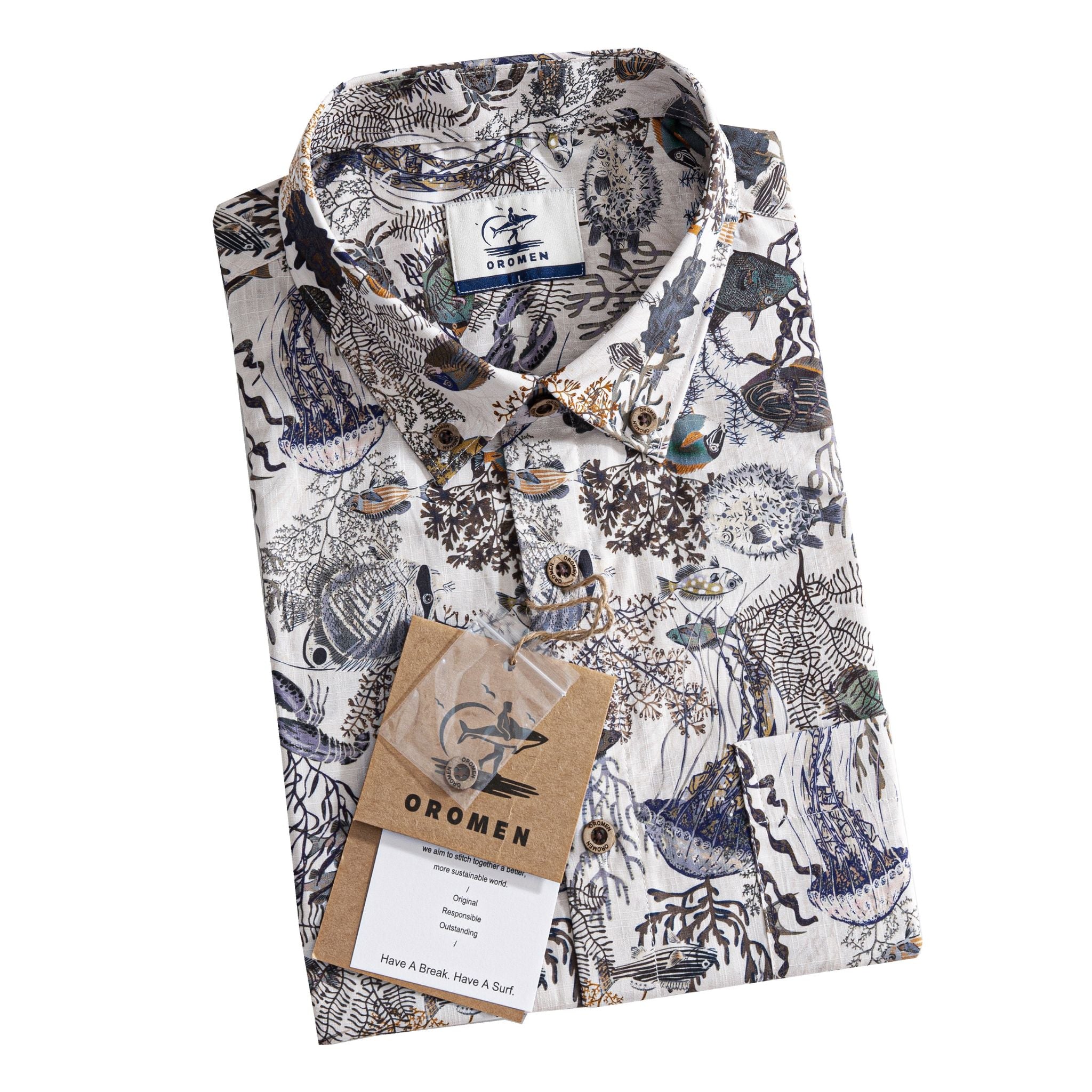 OROMEN Reef Atlas Hawaiian shirt – folded front view showing hand-painted coral reef and tropical fish print on white 100% cotton