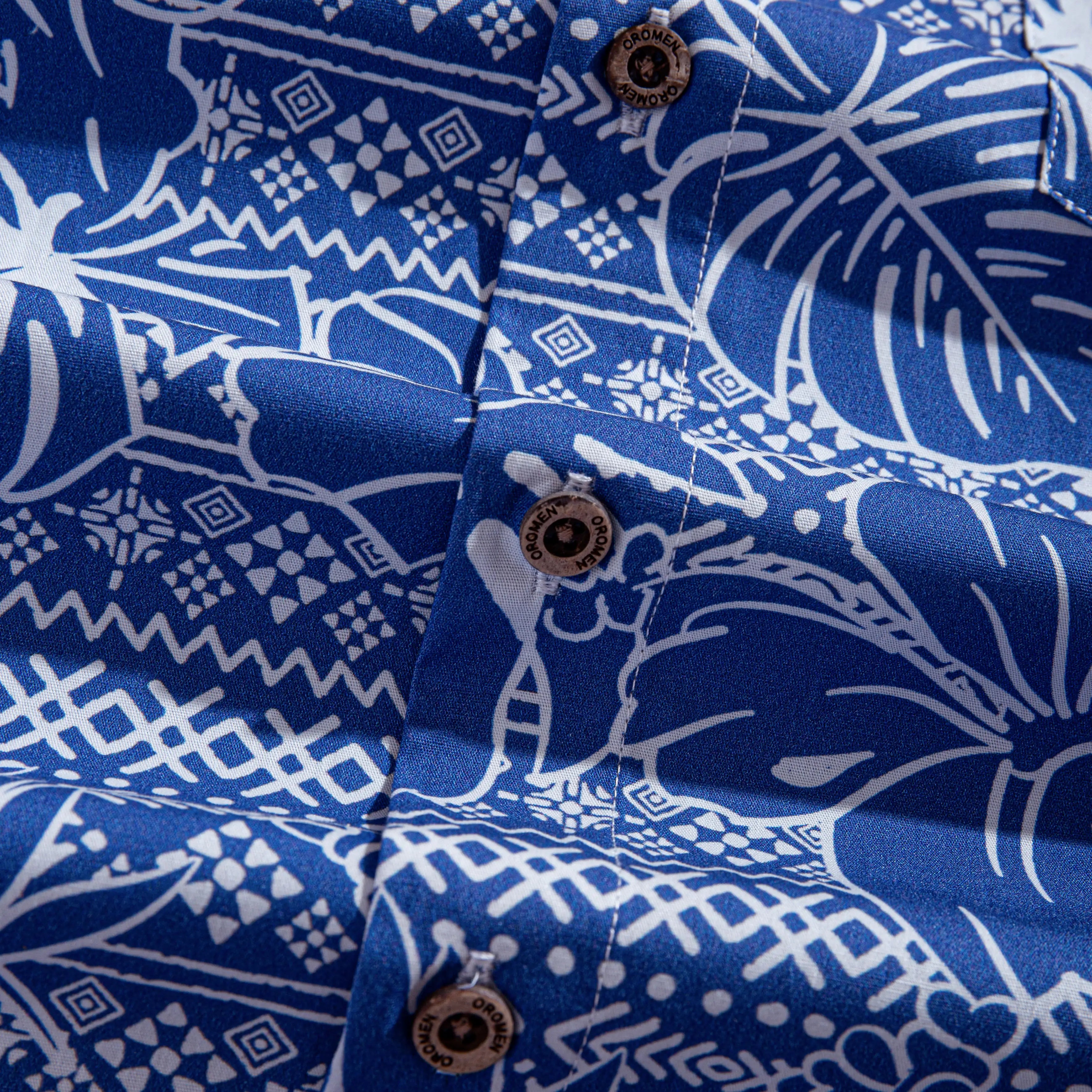 OROMEN branded coconut buttons and retro totem print detail on Plant Totem Hawaiian shirt