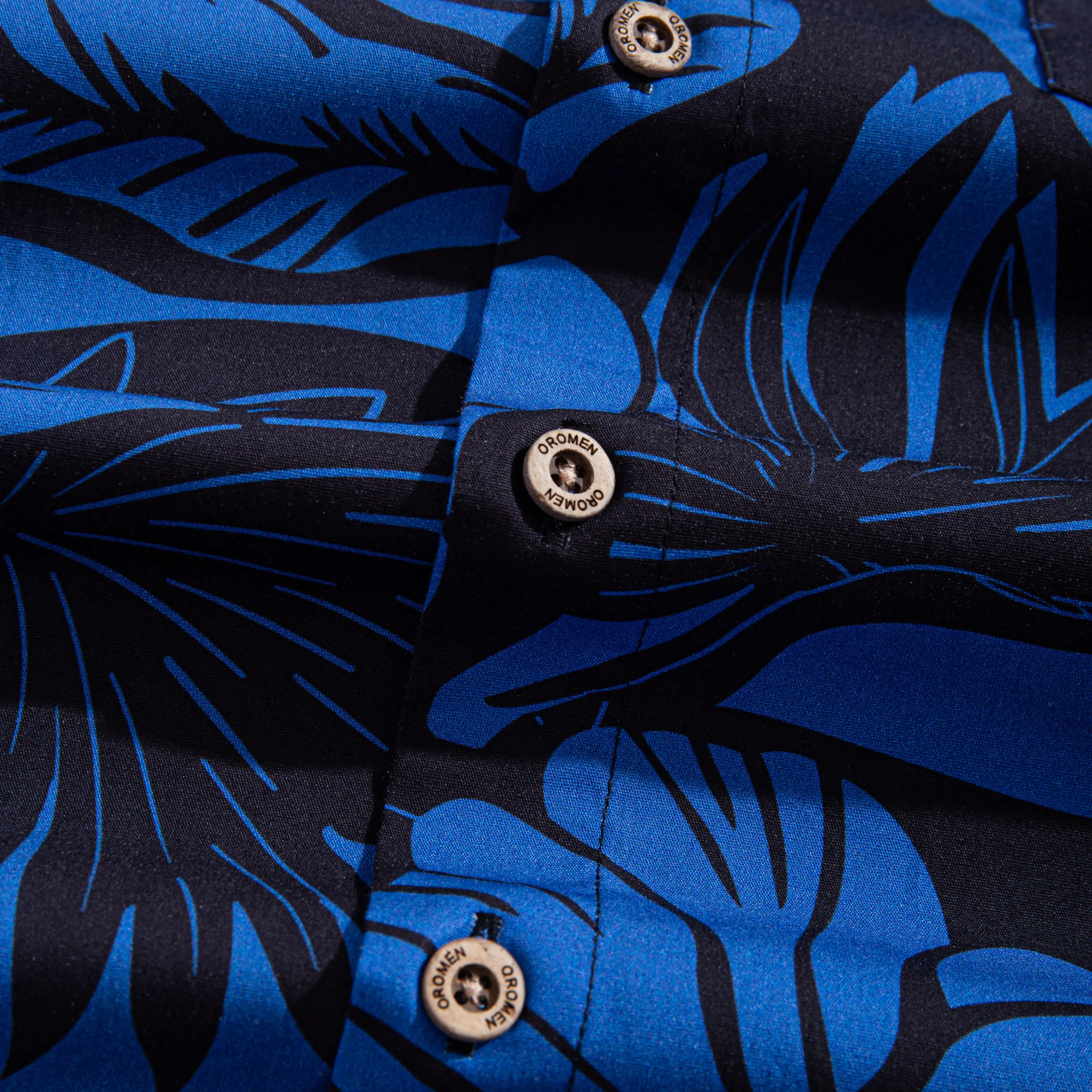 OROMEN branded natural coconut buttons on Blue Bush Hawaiian shirt