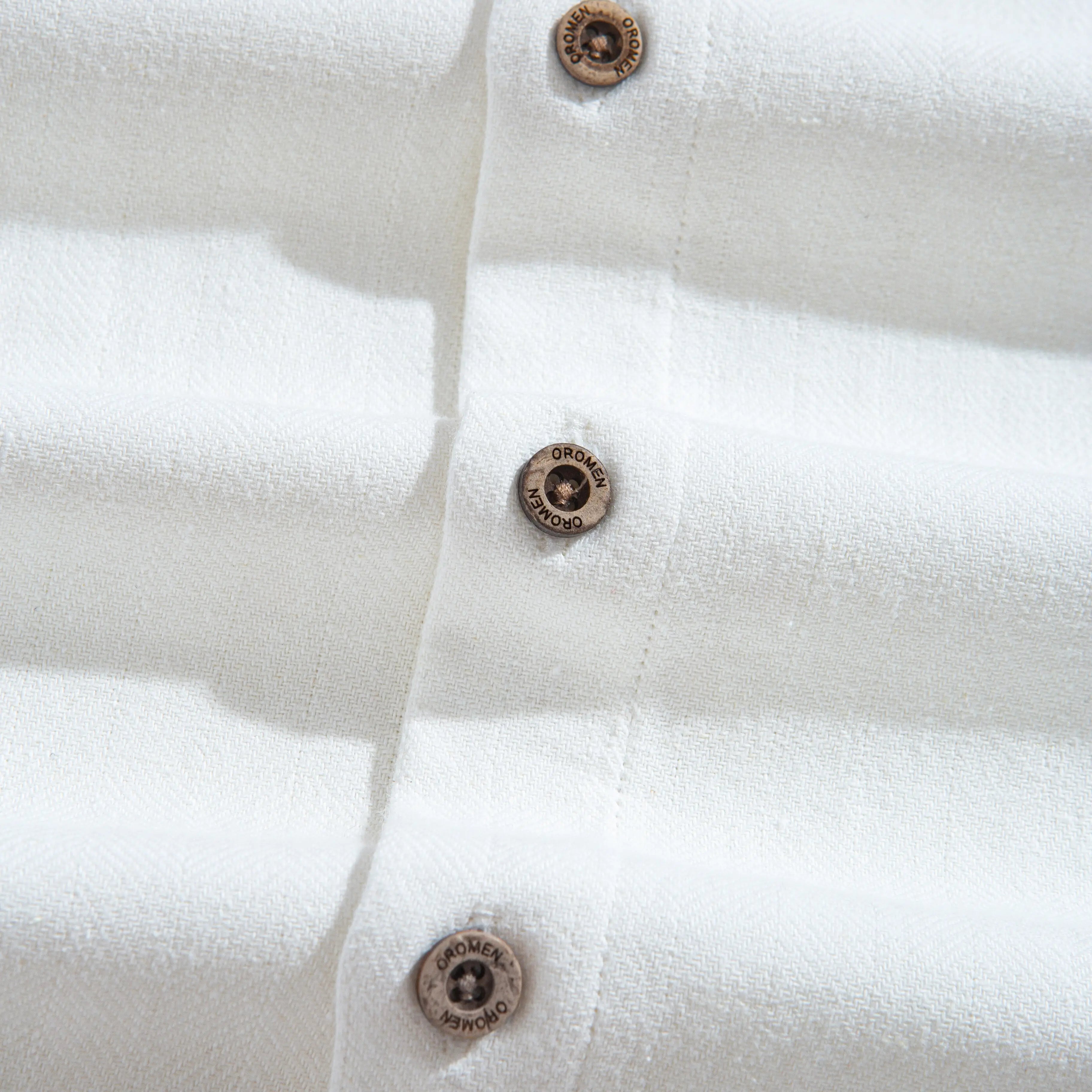 OROMEN engraved coconut buttons on Embossed Striped Shirt – white Tencel™ linen fabric with subtle texture