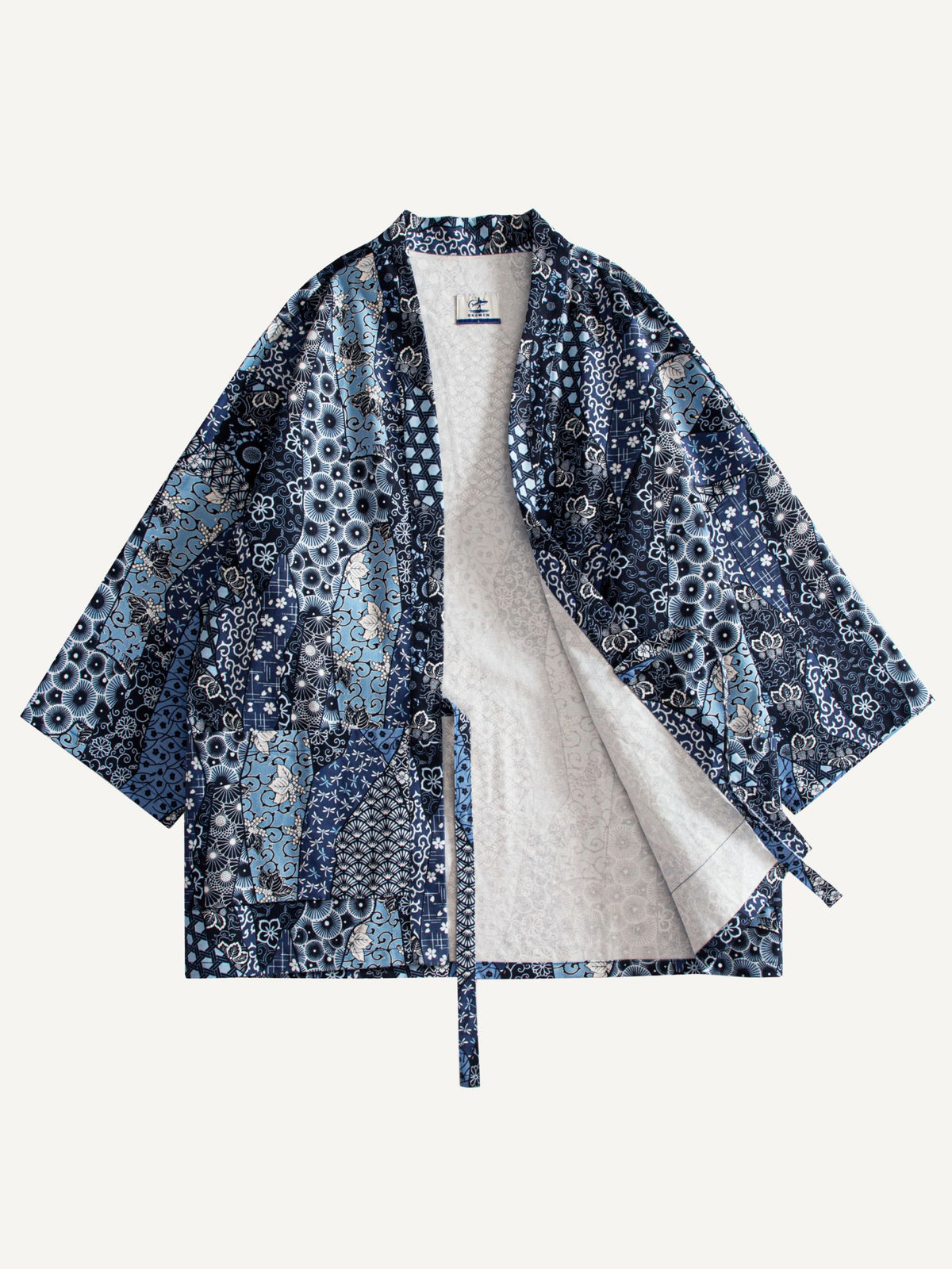 OROMEN indigo floral kimono cardigan with one front panel open, showing off-white lining