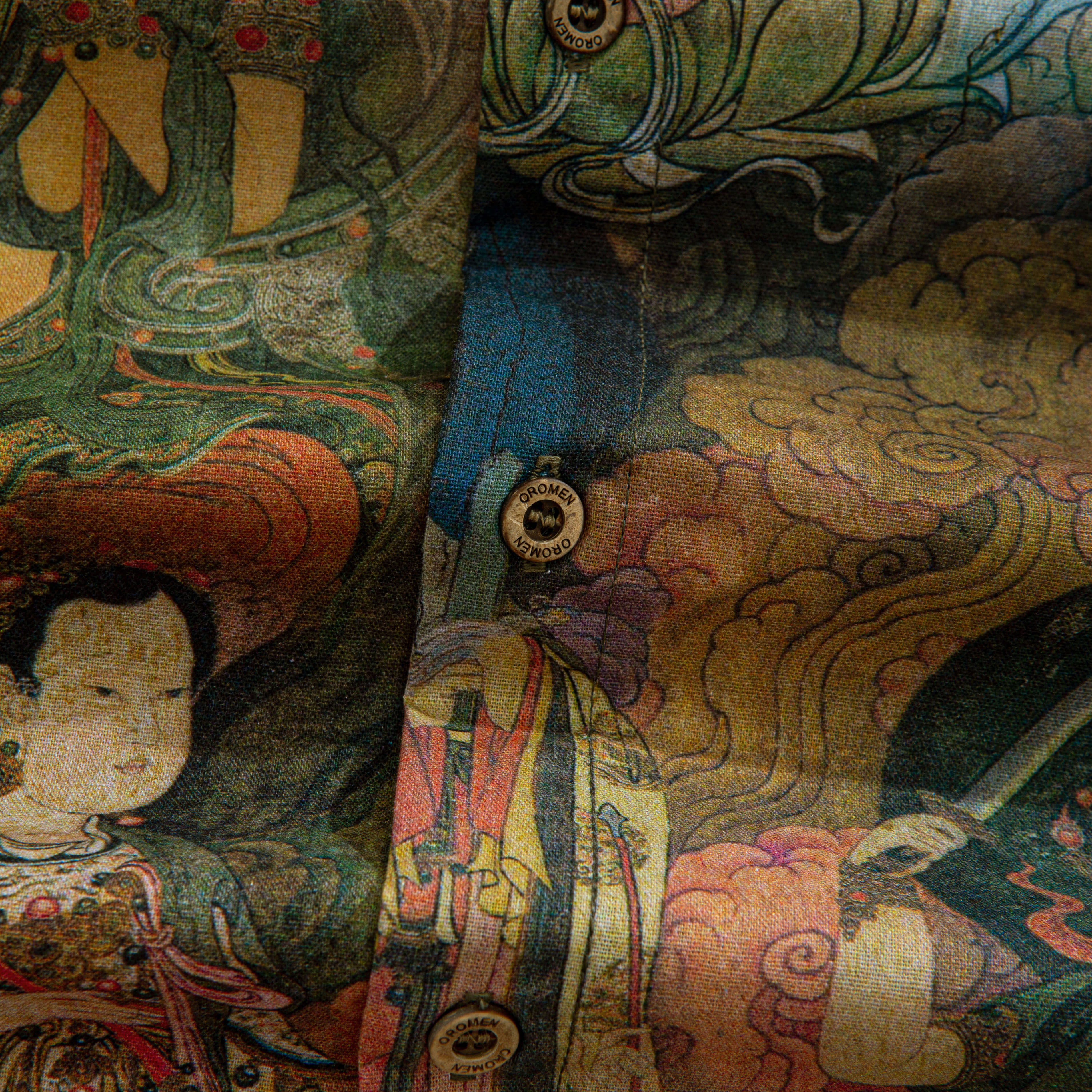 Oriental Buddhist sacred figures hand-painted detail on green cotton shirt