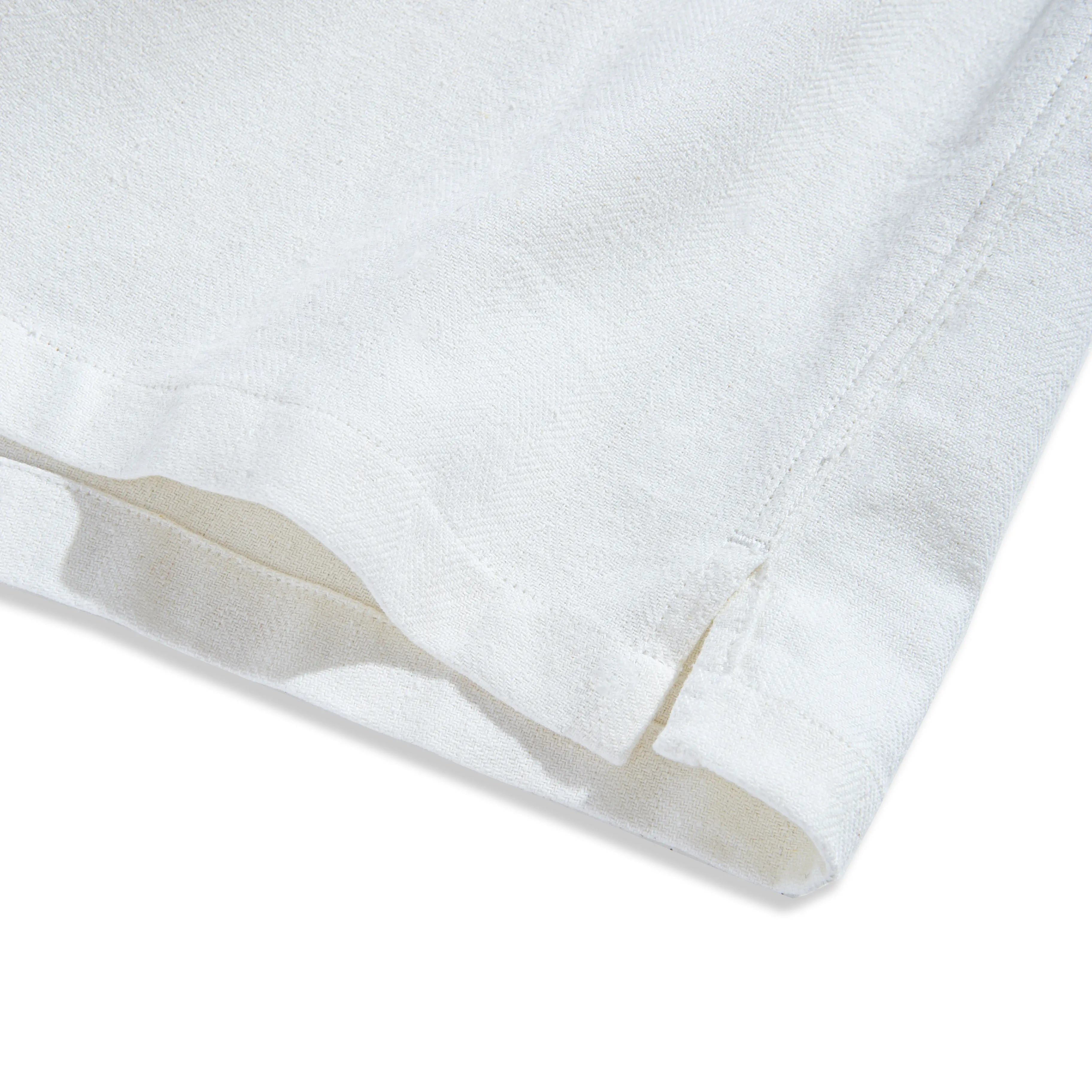 Side vent and double needle stitching detail of OROMEN Embossed Striped Shirt – white Tencel™ linen hem