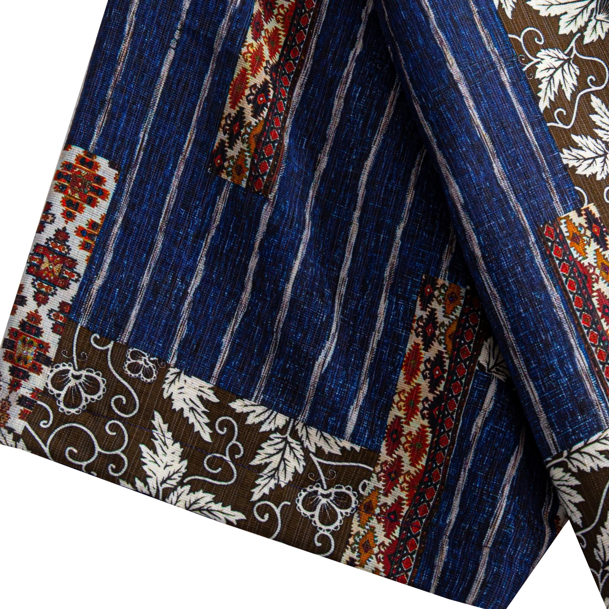 Silk Road Patchwork shirt hem detail showing indigo ikat stripe body, dark brown botanical border and ethnic geometric panels