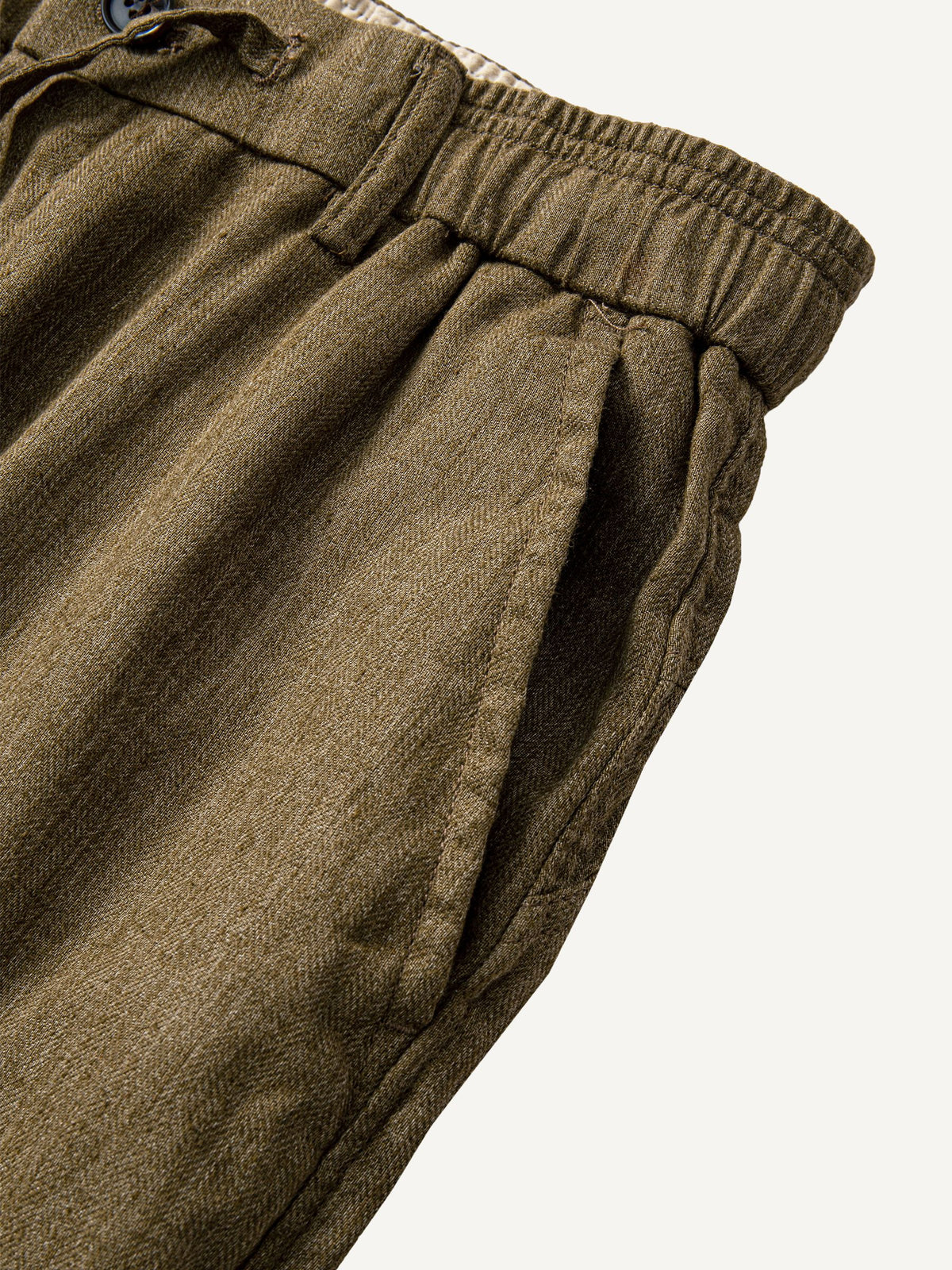 Slant side pocket detail of OROMEN Herringbone Weave Linen Trousers