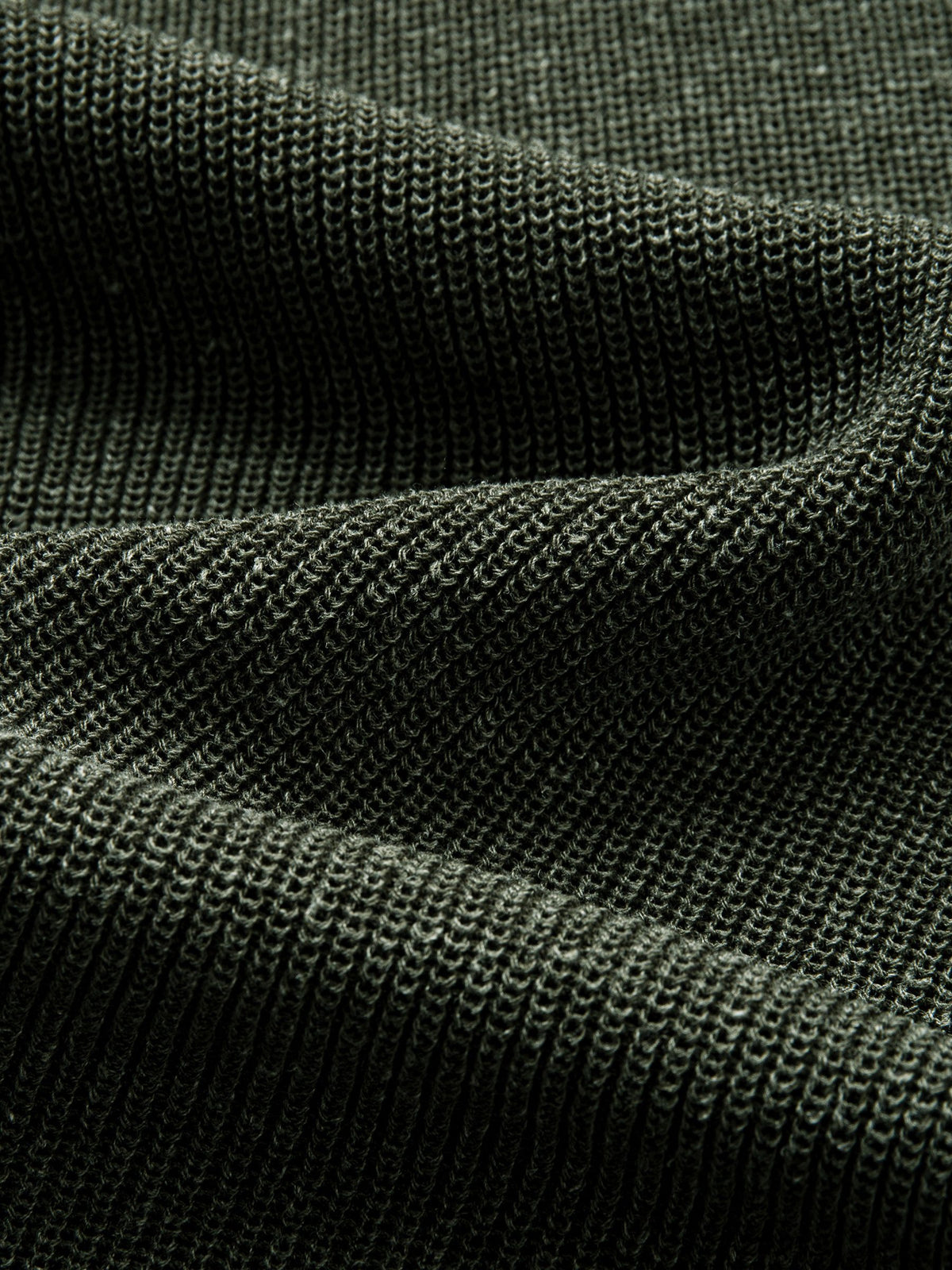 Texture detail of breathable lyocell and linen blend knit fabric in heathered olive green