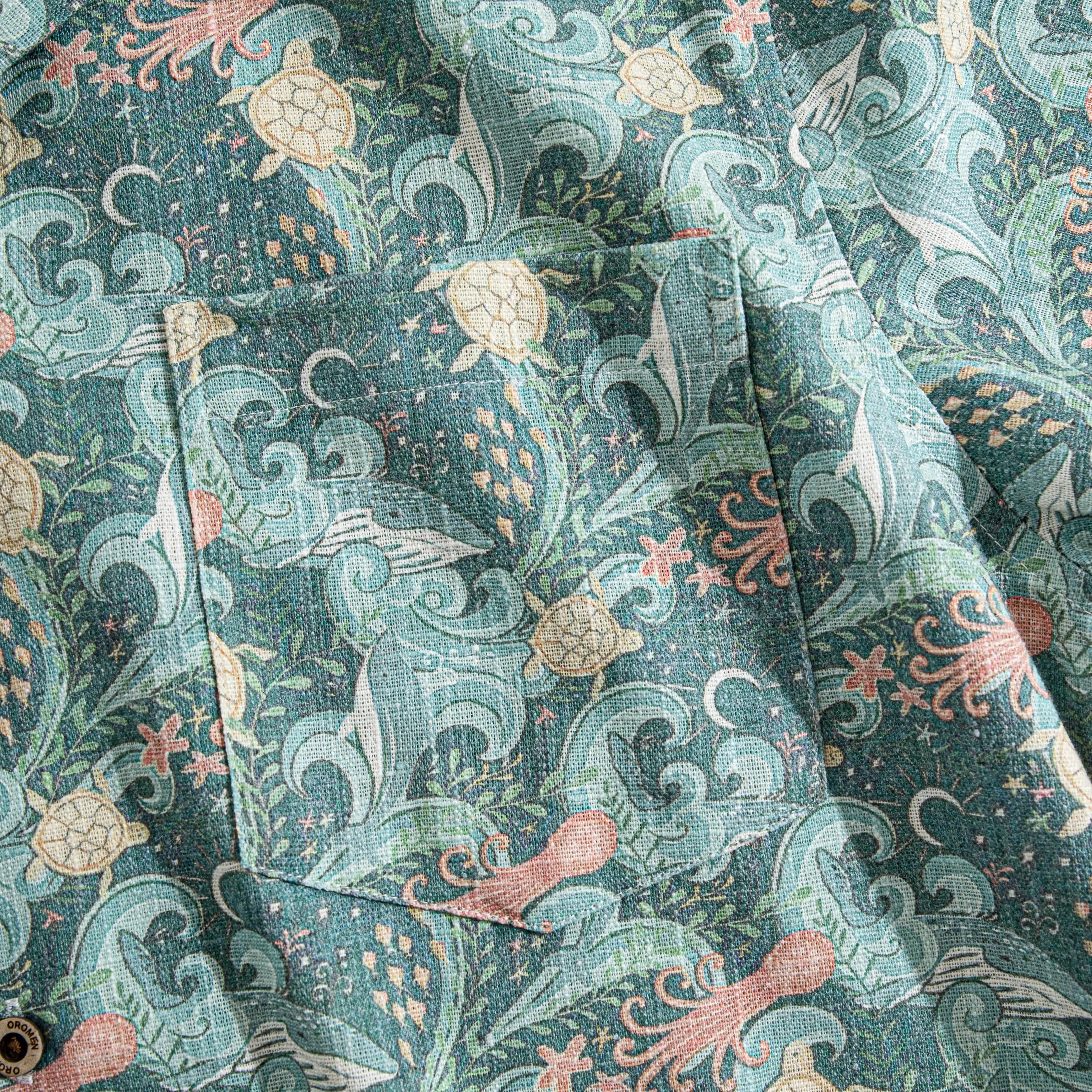 Undersea Oasis green Hawaiian shirt flat lay showing full coral reef design