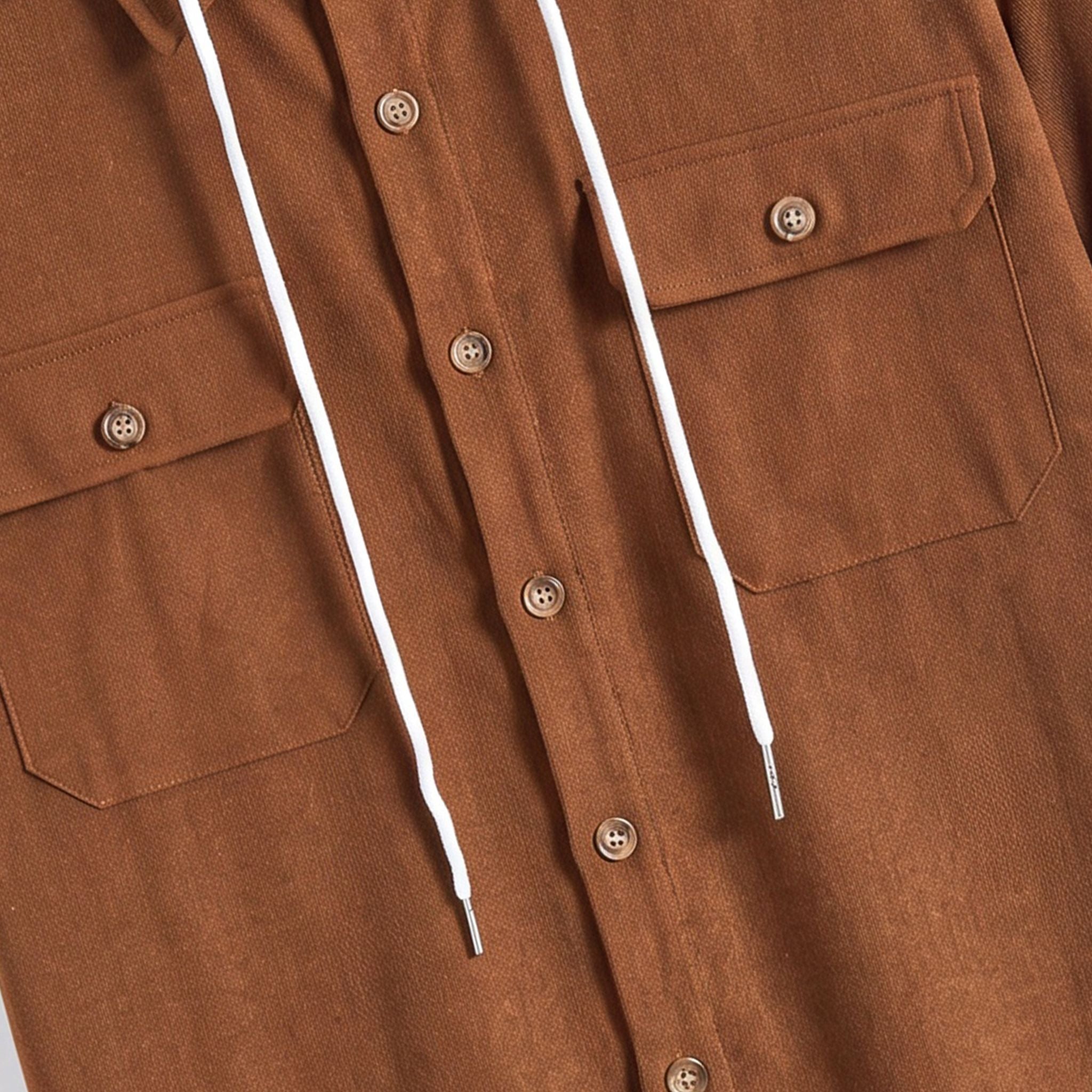 Wooden button and dual flap chest pocket detail on OROMEN rust brown hooded shirt with white drawstring