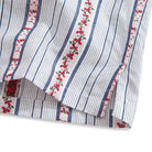 Back detail of striped shirt with box pleat and natural coconut buttons