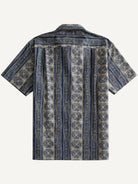 Back flat lay view showing vertical batik stripes of OROMEN Indigo Batik Shirt