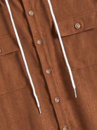Button closure and front placket detail on OROMEN Rust Hooded Utility Shirt