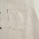Chest pocket detail of OROMEN Versatile Shirt – beige Tencel™ linen with clean patch pocket and coconut button