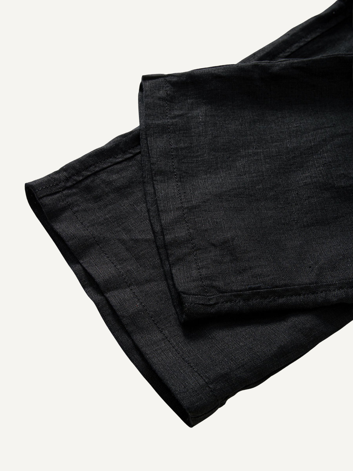 Clean hem and relaxed straight leg cuff detail of OROMEN Crosshatch Weave Drawstring Trousers