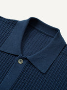 Close-up detail of classic ribbed polo collar and button placket on knit cardigan