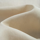 Close-up of OROMEN Versatile Shirt fabric – beige Tencel™ linen blend with silky smooth drape and natural sheen